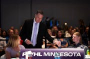 PWHL Minnesota coach Ken Klee fist pumps assistant coach Mira Jalosuo before walking to the stage for the team's No. 3 overall pick in the league draf