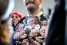 A Bernie Sanders supporter wore a sweatshirt with many faces of Bernie.
