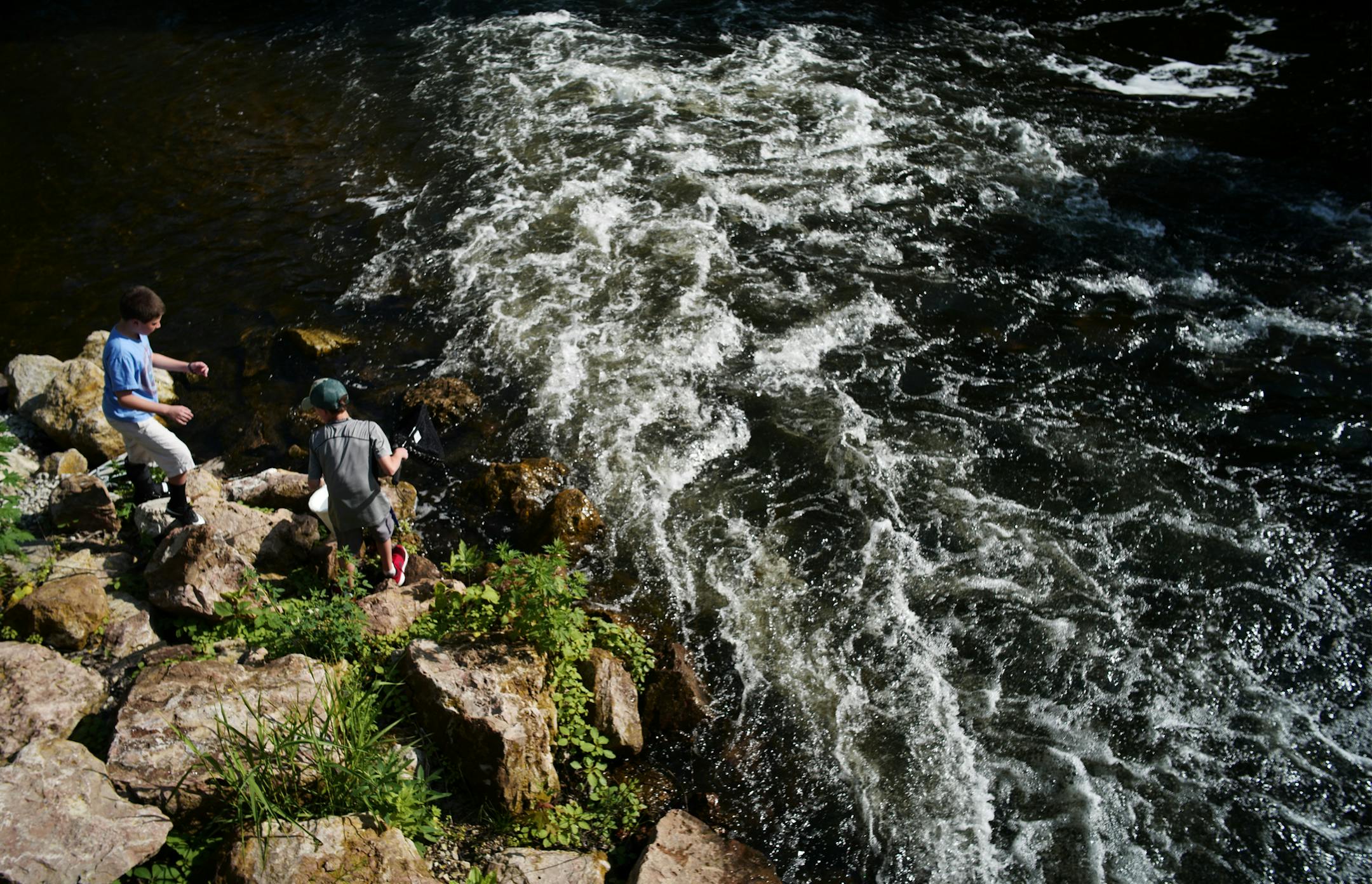 George Heinen,8, left, and Mac Hoeskstra,9, right enjoyed fishing at their favorite spot. Earlier the kids caught and release a 30 inch plus pike.] A secluded fishing hole and cascade in Edina has been a treasured spot not just for the community, but for casual fishers, kayakers and nature lovers in the metro area. However, a $4 million renovation of the parklands would eliminate those rapids, threatening that ecosystem. Richard Tsong-Taatariiïrichard.tsong-taatarii@startribune.com