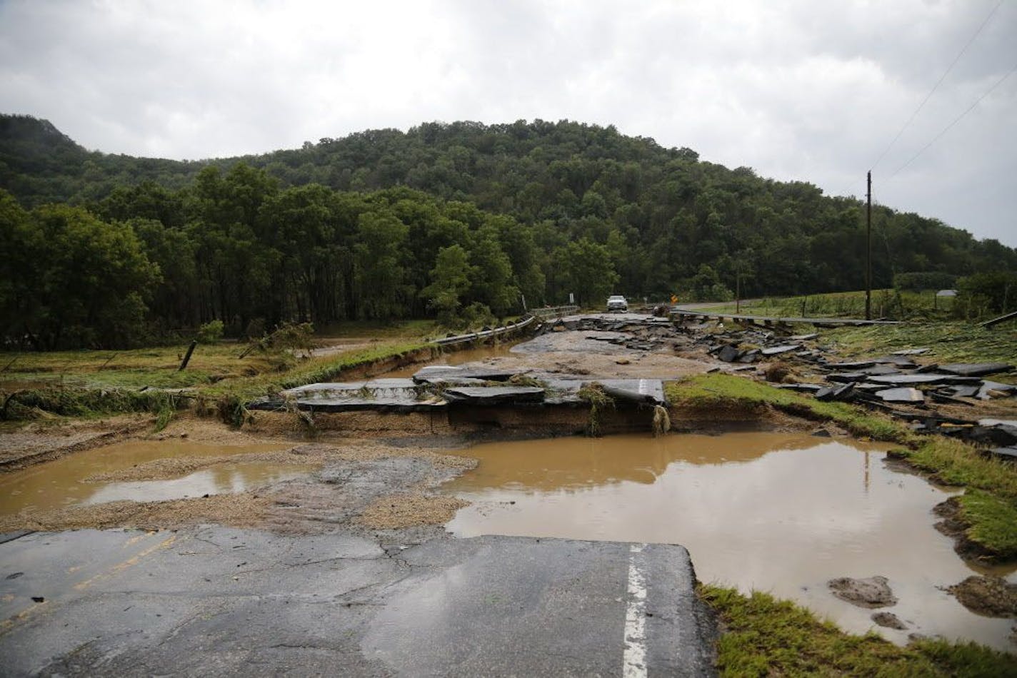 A swollen and raging Coon Creek knocked out a bridge on County Road P several miles outside Coon Valley, Wis., was washed out on Tuesday, August 28, 2018.