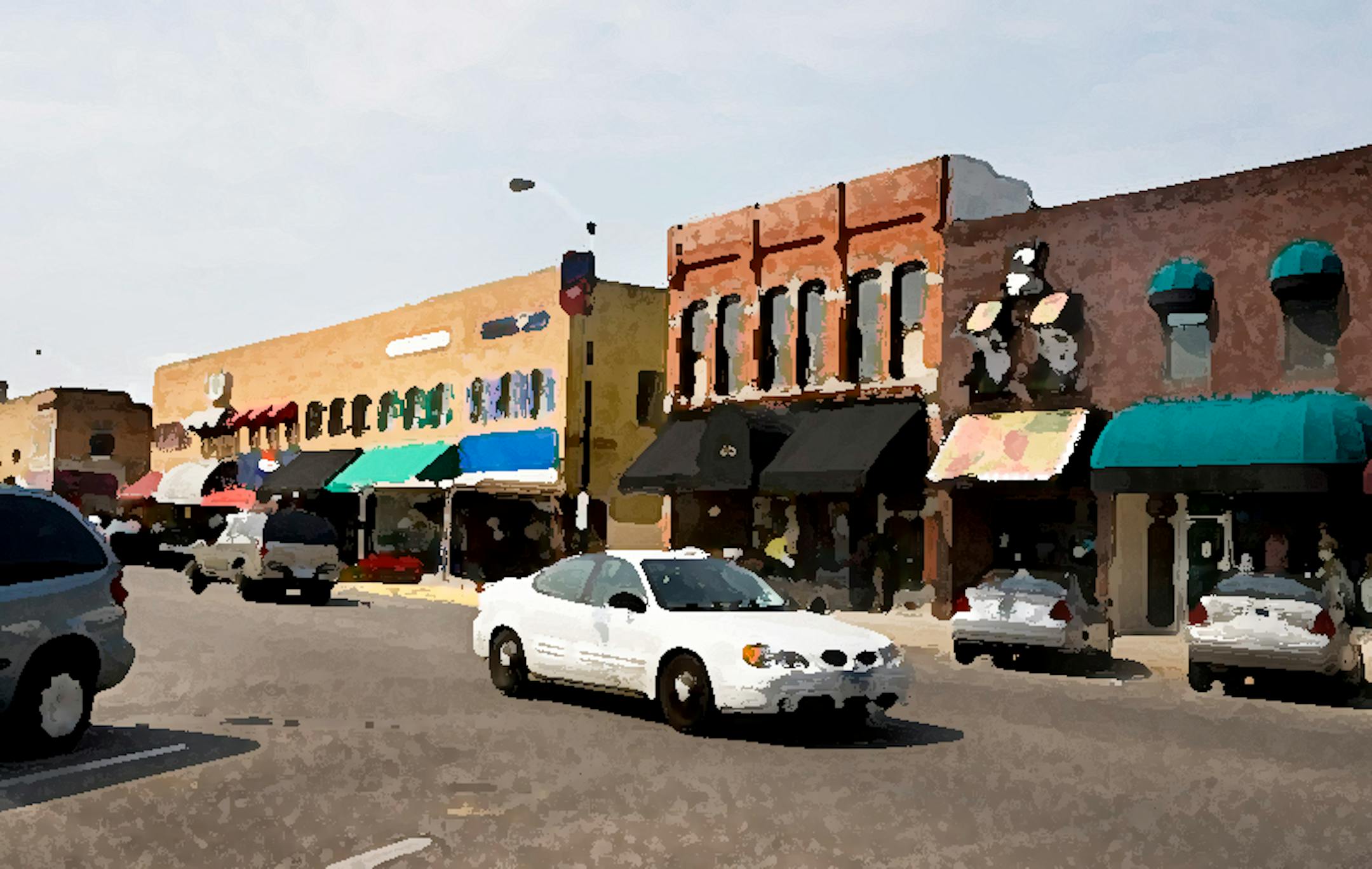 A car drives down North 2nd Avenue past small boutique shops and a coffee house in downtown Newton, Iowa, September 9, 2007. The small community of Newton is dealing with the loss of nearly 2,600 jobs as the town's largest employer Maytag, manufacturer of washers/dryers, begins to shutter its operations after being taken over by rival appliance-maker Whirlpool. (David Lienemann/Chicago Tribune/MCT)