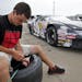 Matthew Ostdiek checked the inflation level of one of his racing tires.
