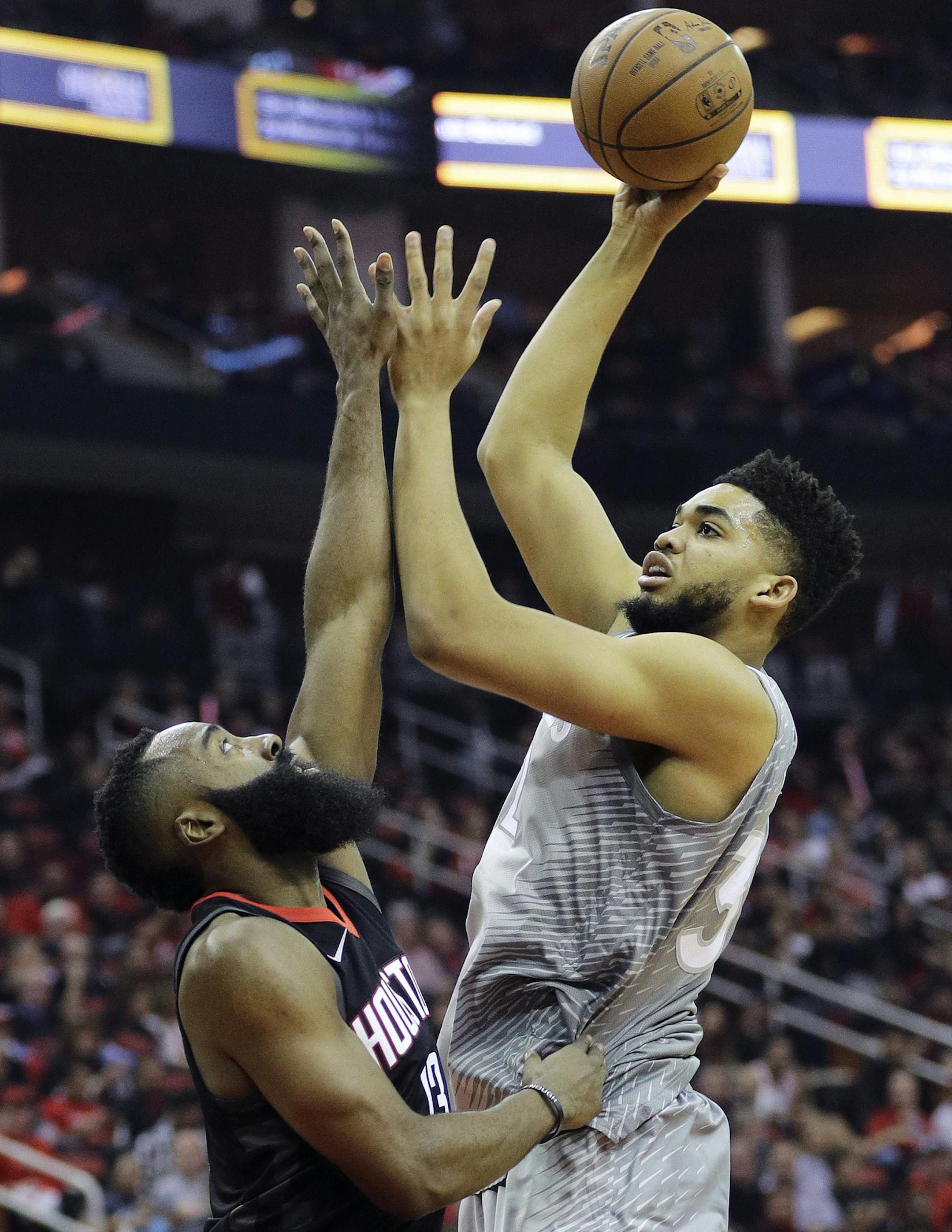 Minnesota Timberwolves' Karl-Anthony Towns shoots over Houston Rockets' James Harden during the first half in Game 1 of a first-round NBA basketball playoff series Sunday, April 15, 2018, in Houston. (AP Photo/David J. Phillip)