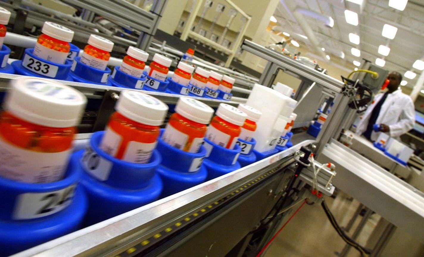 Filled prescriptions zipped down an automated conveyor belt at the Health Partners prescription-filling facility in Eden Prairie.