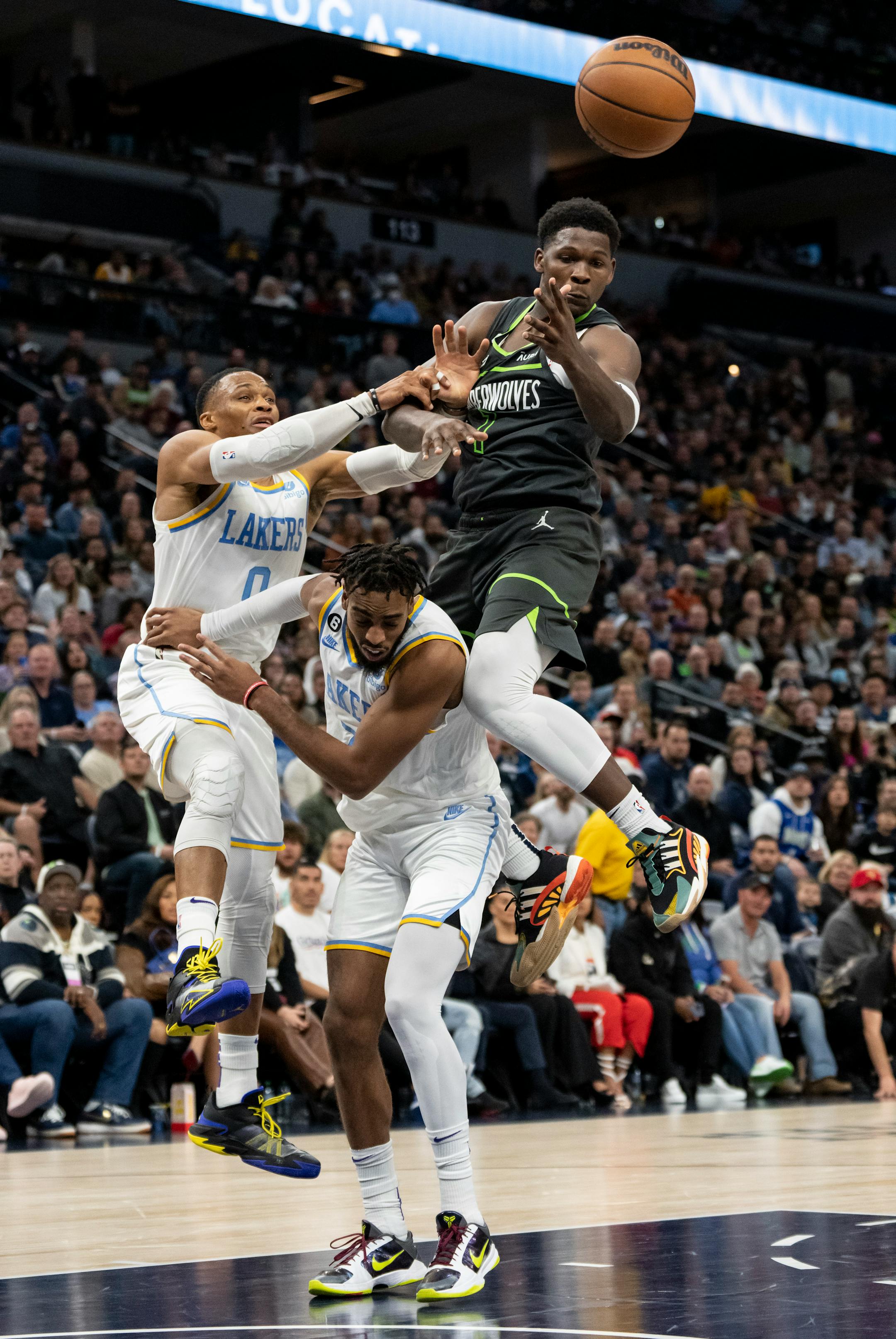 Los Angeles Lakers guard Russell Westbrook (0), Los Angeles Lakers forward Troy Brown Jr. (7) and Minnesota Timberwolves forward Anthony Edwards (1) get tangled reaching for a pass in the fourth quarter.