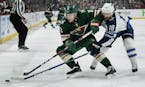 The Minnesota Wild's Charlie Coyle (3) and the Winnipeg Jets' Bryan Little (18) battle for the puck in the first period during Game 4 of the first-rou