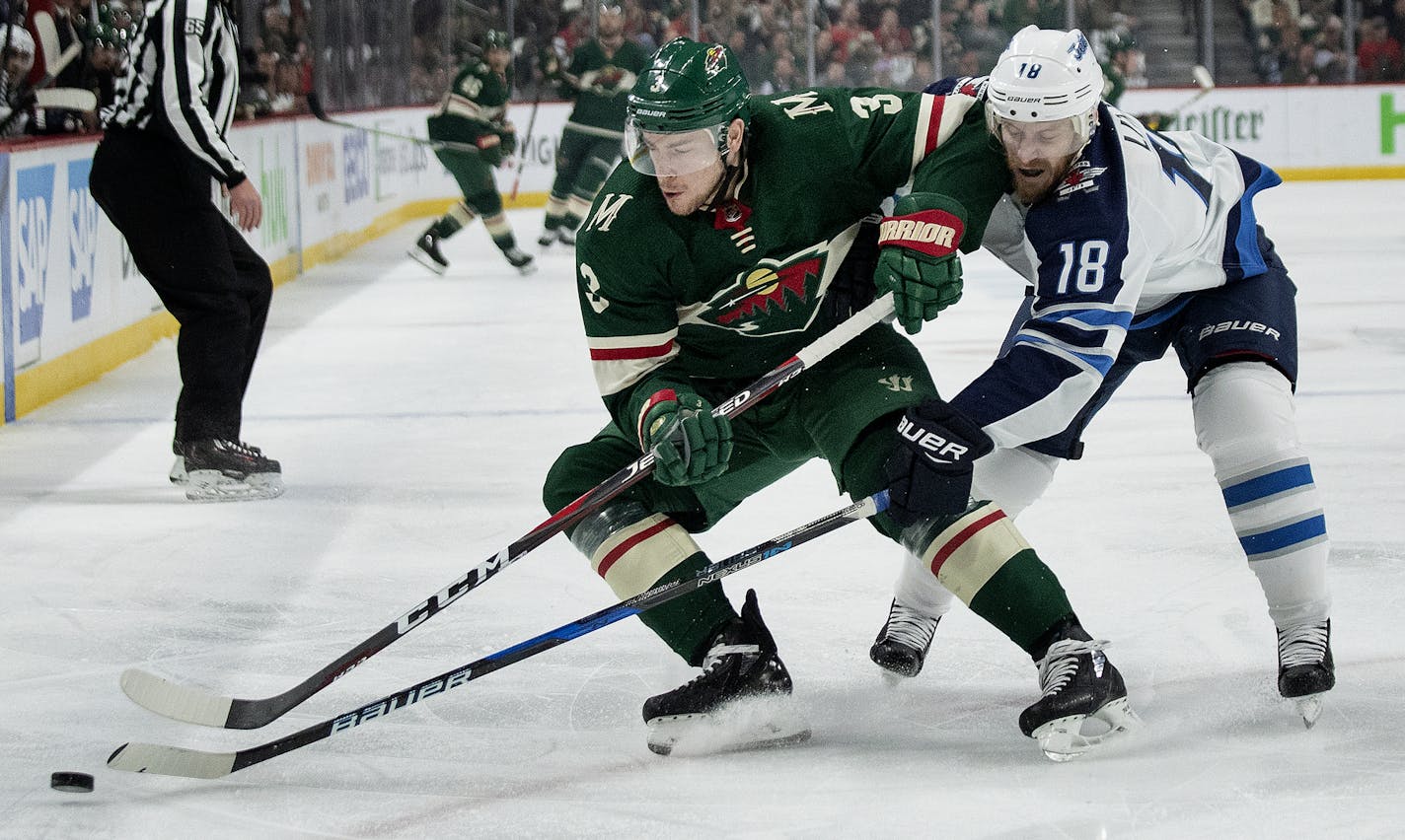 The Minnesota Wild's Charlie Coyle (3) and the Winnipeg Jets' Bryan Little (18) battle for the puck in the first period during Game 4 of the first-round Stanley Cup Playoff series on Tuesday, April 17, 2018, at the Xcel Energy Center in St. Paul, Minn. The Jets won, 2-0, for a 3-1 series lead. (Carlos Gonzalez/Minneapolis Star Tribune/TNS) ORG XMIT: 1228882