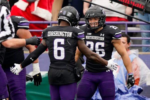 Northwestern running back and Maple Grove native Evan Hull, right, celebrated with wide receiver Malik Washington after scoring a touchdown in last we