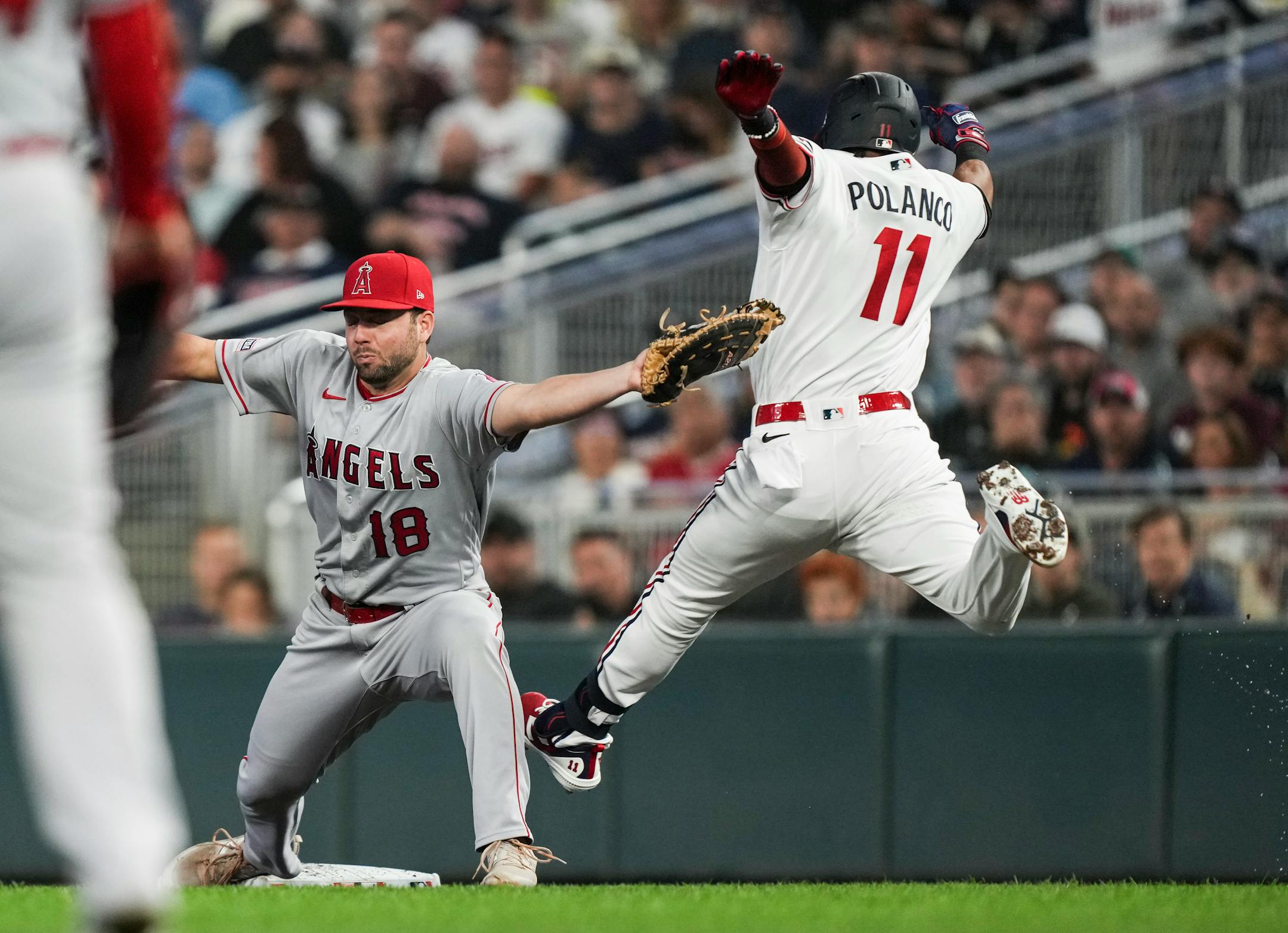 Los Angeles Angels first baseman Nolan Schanuel (18) catches the ball ahead of Minnesota Twins designated hitter Jorge Polanco (11) for a Twins out in the first inning. The Minnesota Twins hosted the Los Angeles Angels at Target Field on Friday, Sept. 22, 2023 in Minneapolis, Minn. ] RENEE JONES SCHNEIDER • renee.jones@startribune.com
