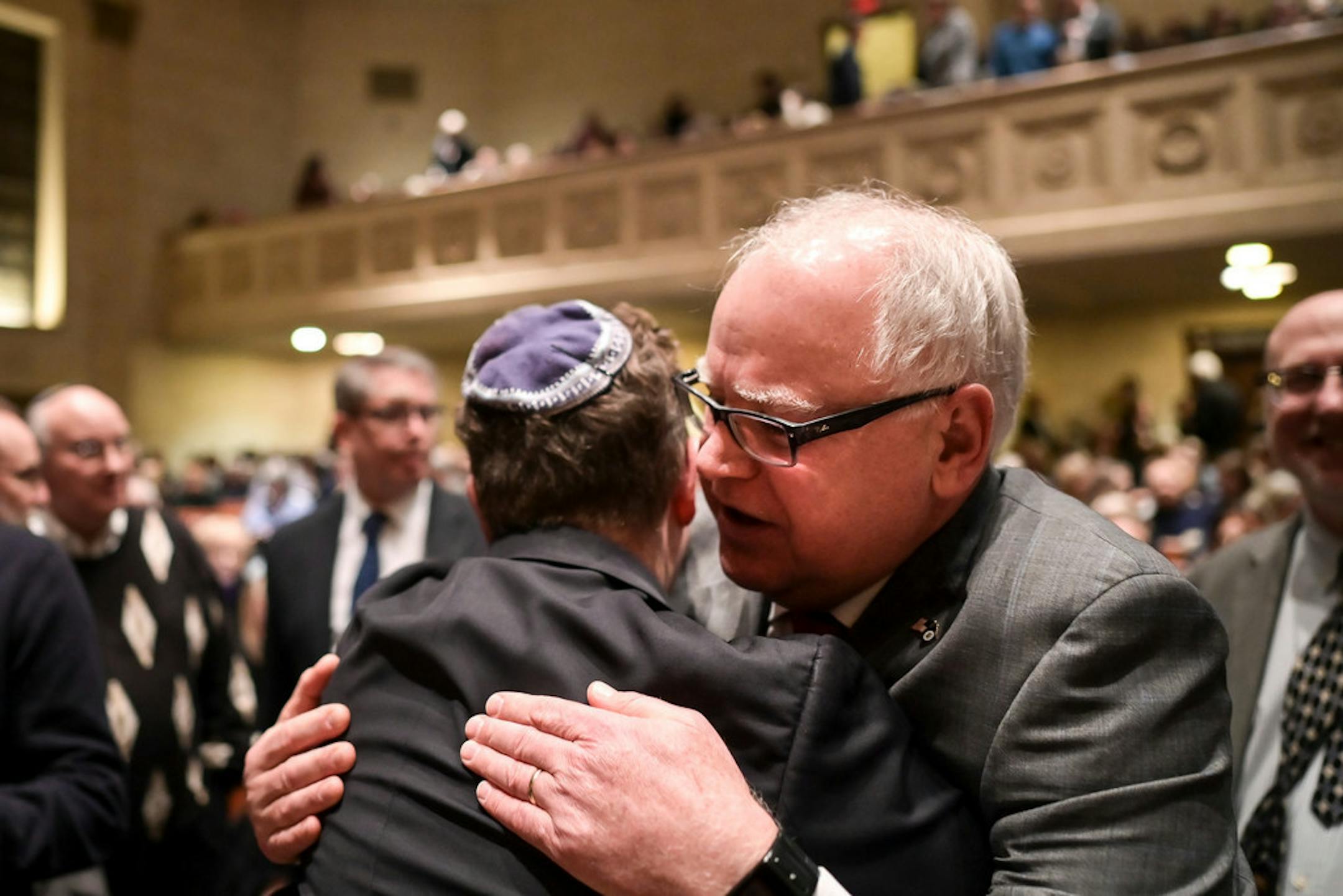 Gov. Tim Walz greeted Steve Hunegs, executive director of the Jewish Community Relations Council, as Walz arrived at Temple Israel for Tuesday night's solidarity event against anti-Semitism.