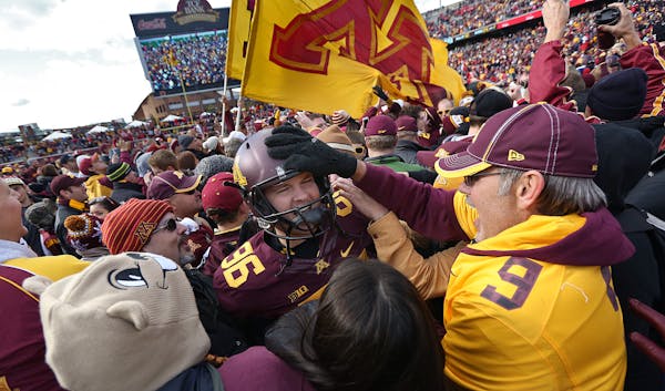 Dave Ramlet was mobbed by fans after the Gophers&#x2019; 34-23 victory over Nebraska on Oct. 27 at TCF Bank Stadium.