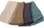 four folded different color leggings, light skin, skin color,dark gray and green. istock