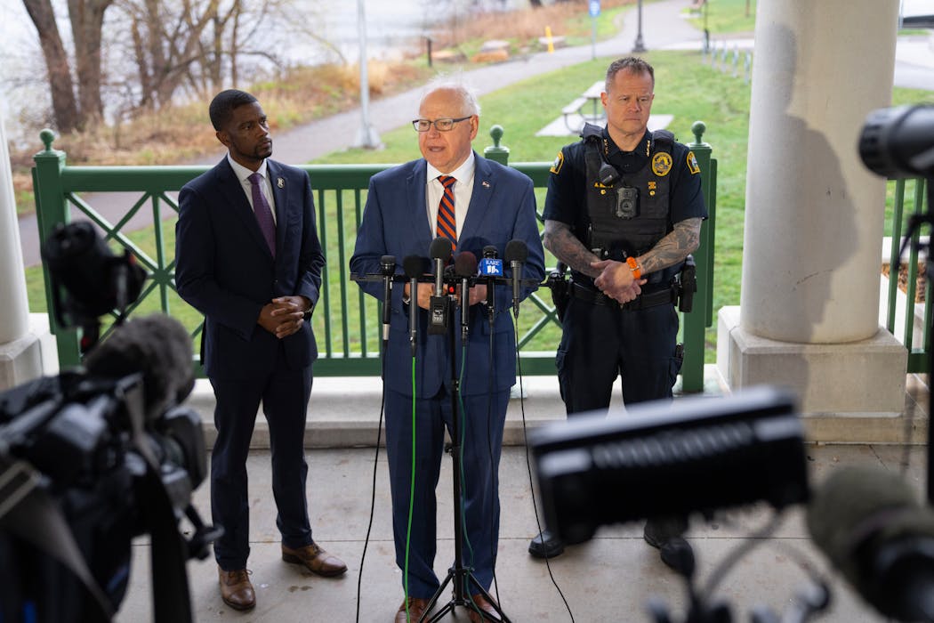 Minnesota Governor Tim Walz is flanked by St. Paul Mayor Melvin Carter and Police Chief Axel Henry, left to right, during a press conference at Como Lakeside Pavilion in St. Paul on Wednesday. Governor Tim Walz met with St. Paul Mayor Melvin Carter, Police Chief Axel Henry and Parks and Recreation Director Andy Rodriguez to discuss legislation geared toward curbing copper theft.