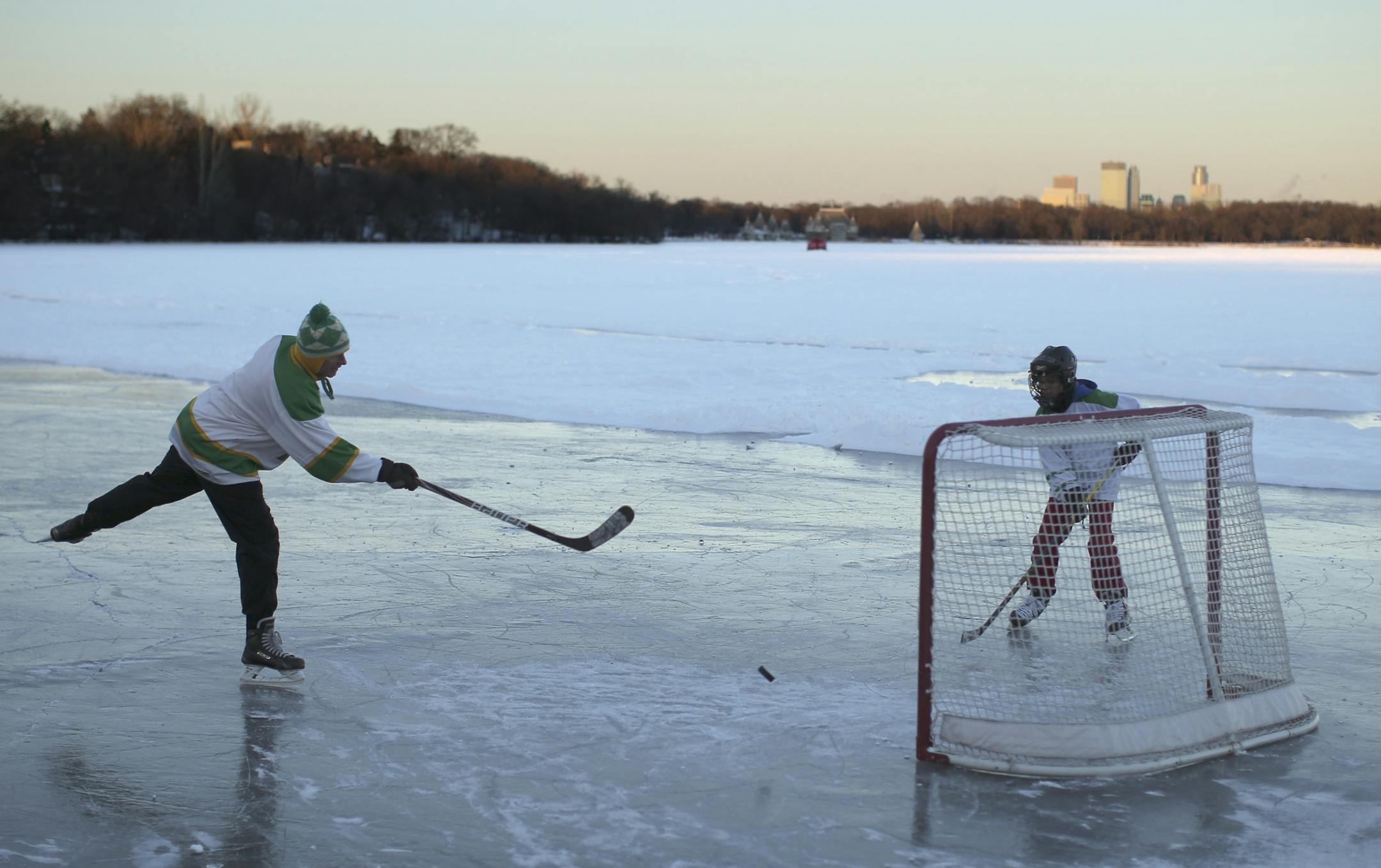 With the temperature trying to rise above zero and a wind chill of -20 degrees late Sunday afternoon, John Rosengren and his son, Brendan, 12, played hockey on the rink John cleared at the south end of Lake Harriet. "I love hockey. I grew up playing hockey on a frozen pond and those are some of my happiest memories," Rosengren said. ] JEFF WHEELER &#x201a;&#xc4;&#xa2; jeff.wheeler@startribune.com Minnesotans are facing several days of cold weather ahead. On Lake Harriet in Minneapolis, with the