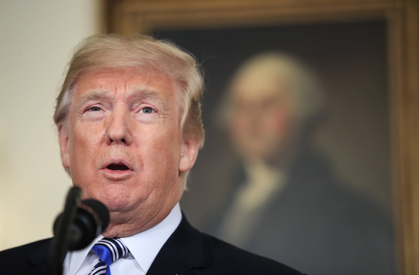 President Donald Trump speaks in the Diplomatic Room of the White House in Washington, Friday, March 23, 2018, about the $1.3 trillion spending bill. (AP Photo/Manuel Balce Ceneta)