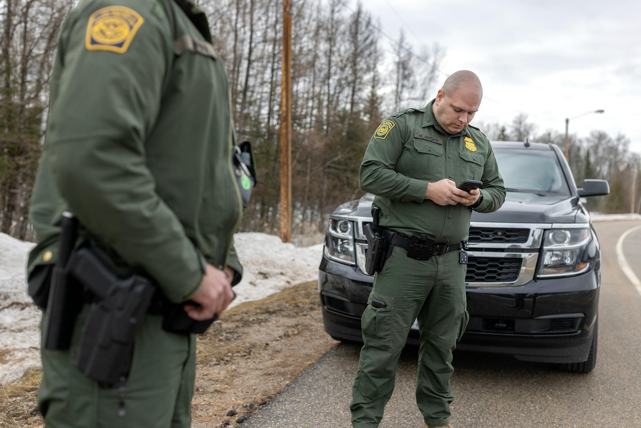 Border Patrol Agents Jared Berg, left, and Mike Johnson, show the vastness of the area near Roseau, Minn., on Tuesday, March 22, 2022.