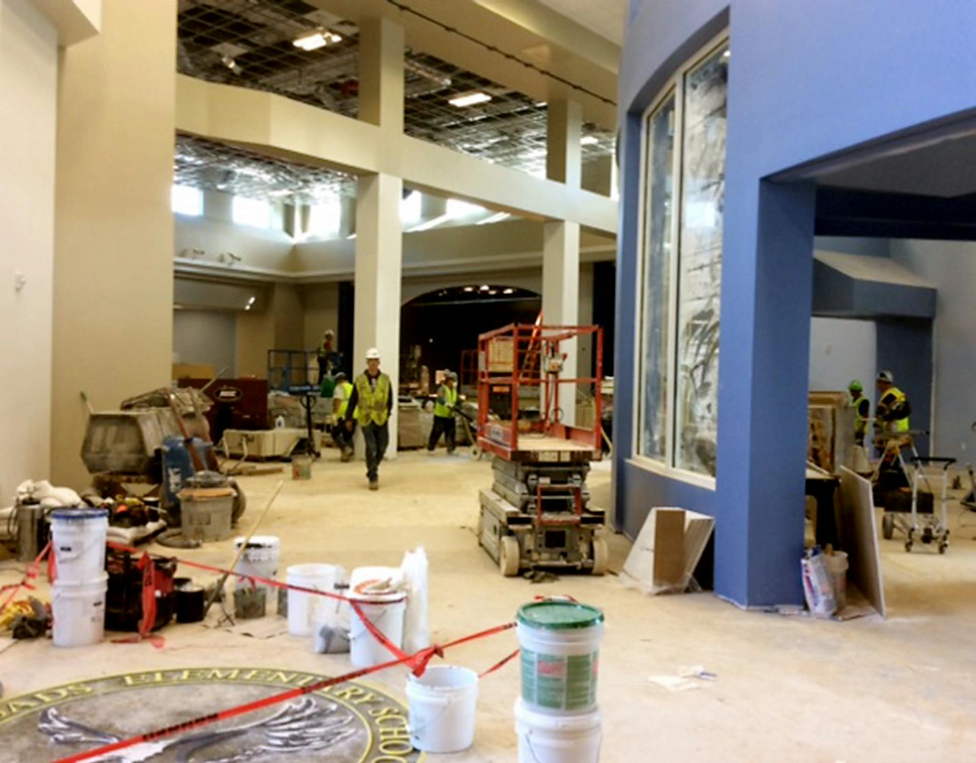 Construction crews were putting the finishing touches the Crossroads Elementary commons area this fall. The area features natural light and is bordered by a media center, a stage and a kitchen with specialized equipment for serving fresh foods. A decoration in the floor is emblazoned with the school&#x201a;&#xc4;&#xf4;s name and its new mascot. ] JILL BURCUM/STAR TRIBUNE