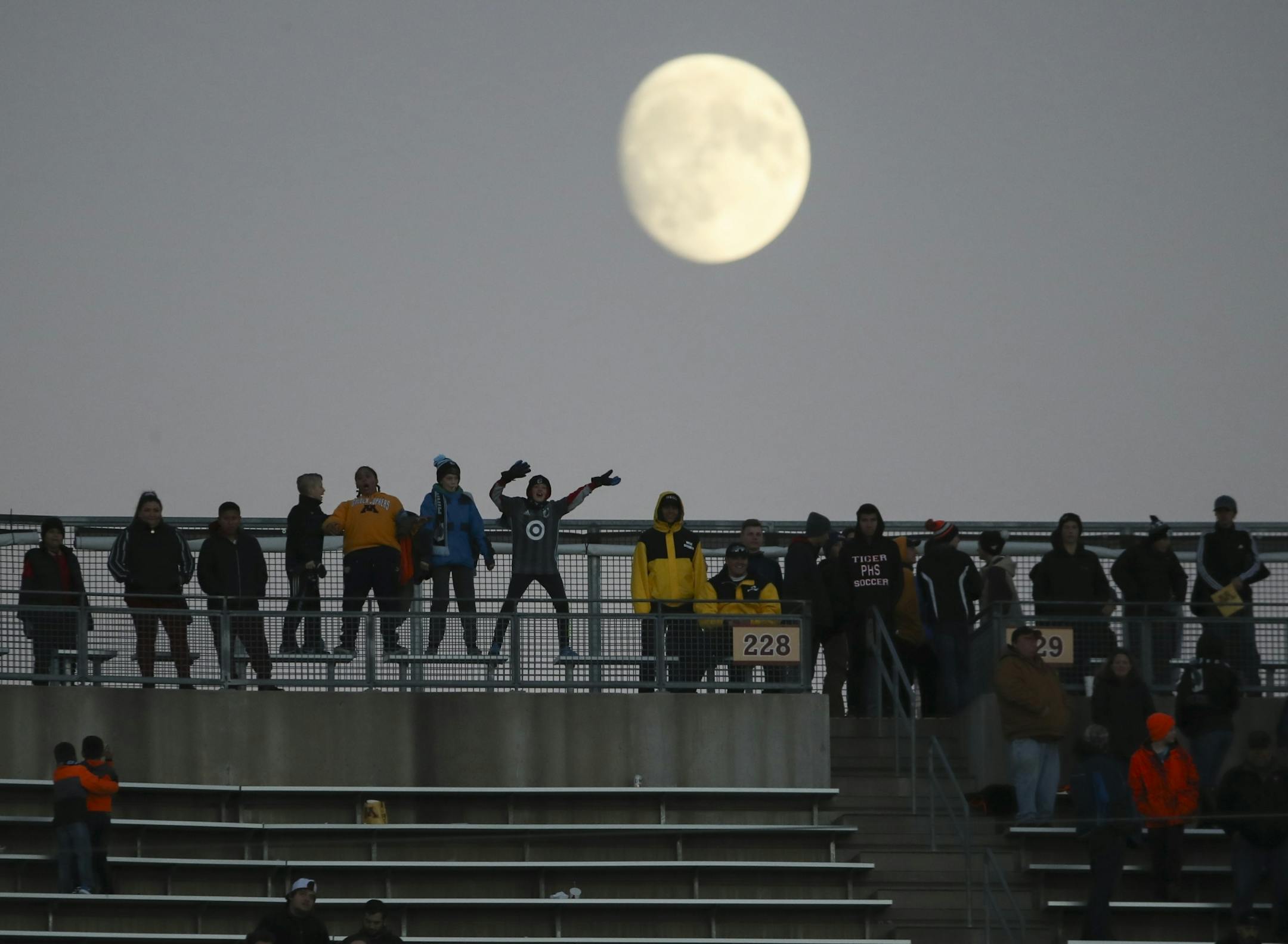 Fans lingered in the stadium as the moon rose shortly after the game ended.