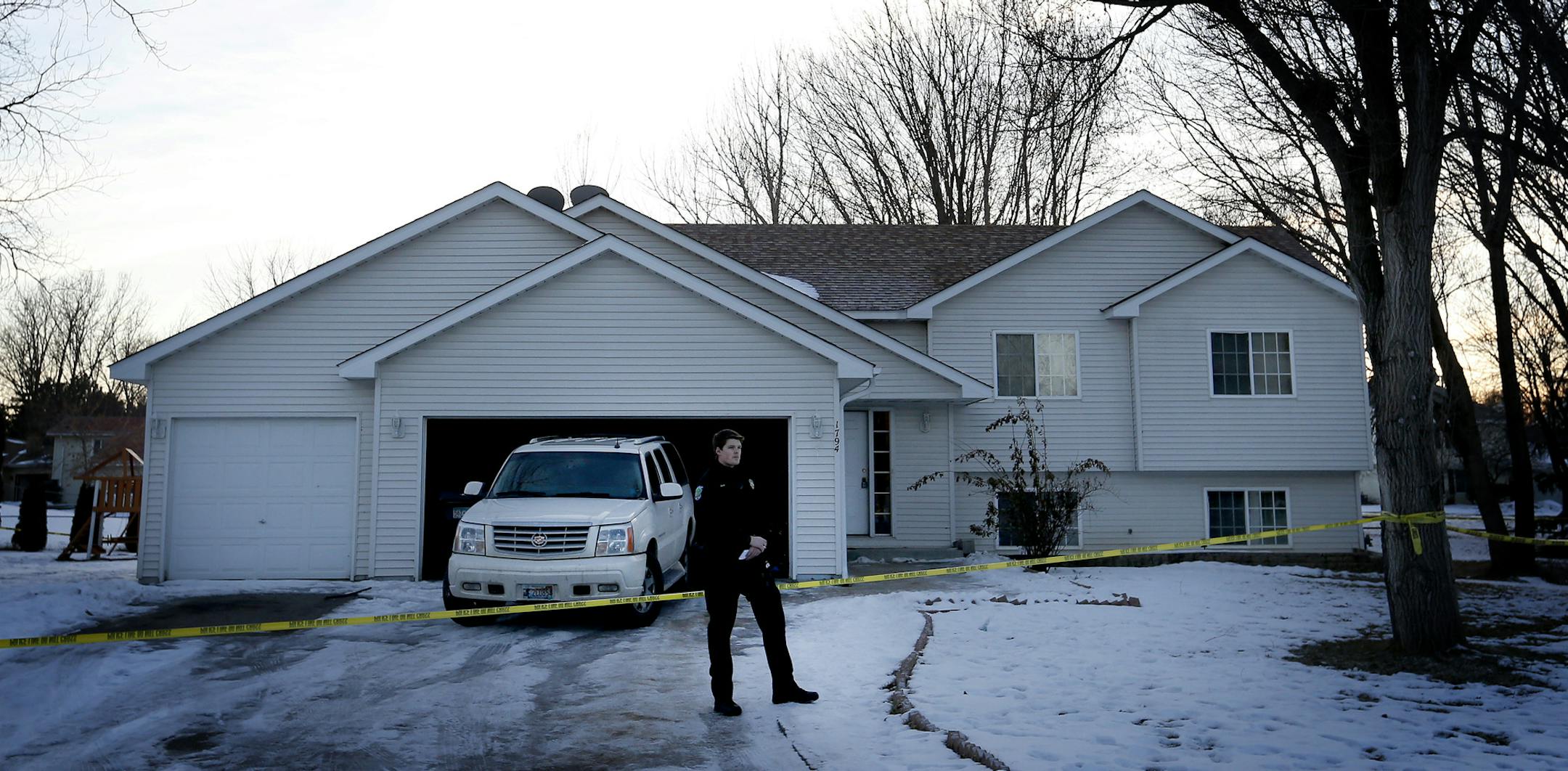 A police officer stood in front of home on the 1700 block of Silver Bell Circle in Eagan Sunday evening.