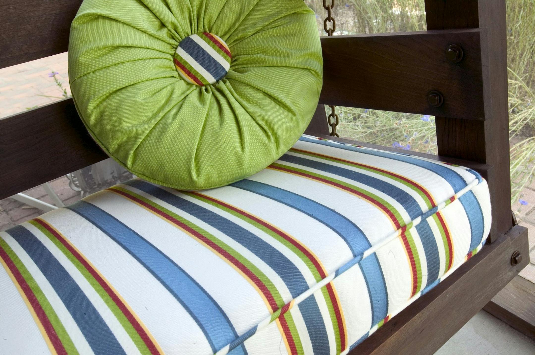 KRT LIFESTYLE STORY SLUGGED: HOME-OUTDOORFABRICS KRT PHOTO BY JOHN MUTRUX/KANSAS CITY STAR (July 14) Laura Gendron of Plattsburg, Missouri, had outdoor cushions custom-made for her porch swing. The fabric is a new line of Sunbrella that feels similar to cotton. (gsb) 2005 ORG XMIT: 1019553