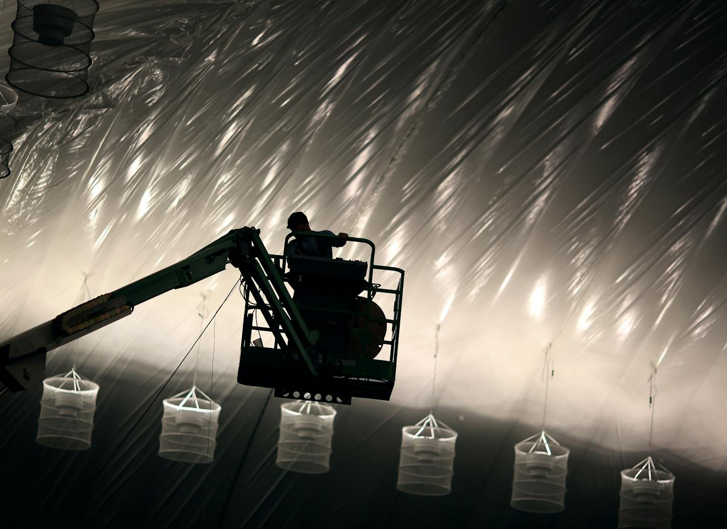 Curtis Morice used a lift to install emergency lighting at the new inflatable sports dome structure in Edina Wednesday December 3, 2014 in Edina, MN. ] Jerry Holt Jerry.holt@startribune.com