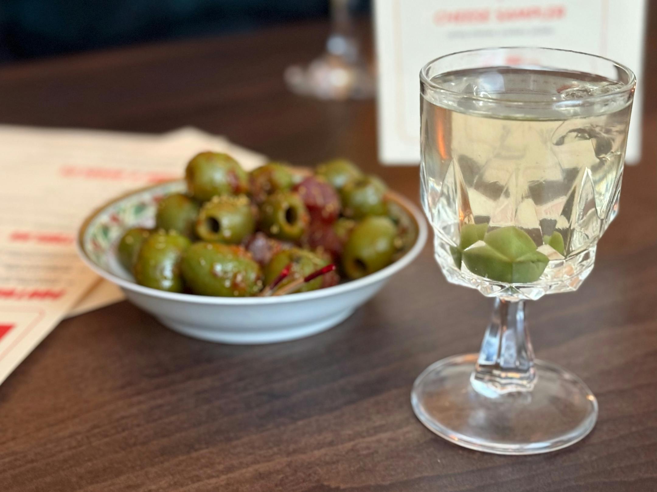 Steady Pour small martini with warm, spiced olives from Jook Sing chefs Tony Gao and Mike Yuen.
