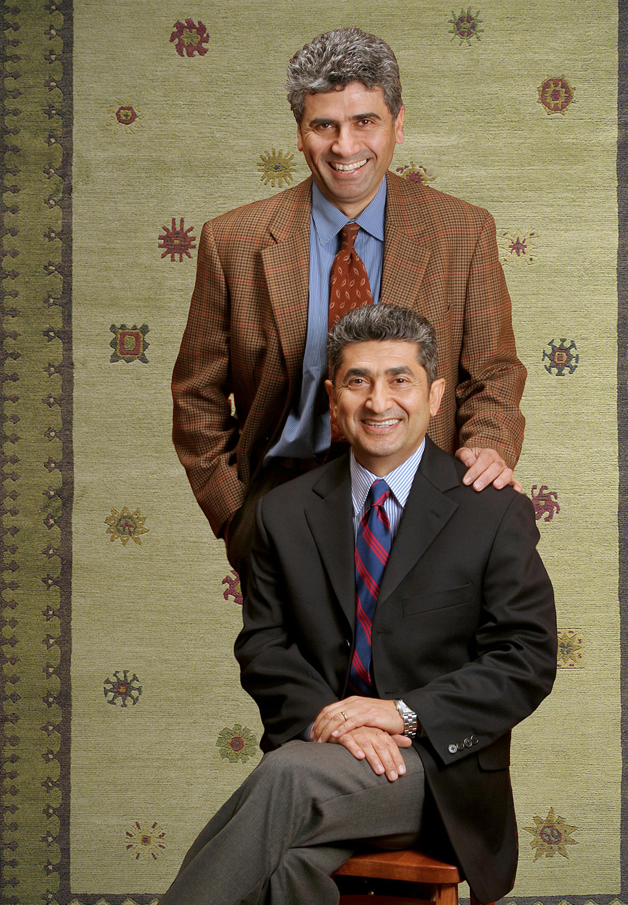 Farzan Navab (standing) and Sam Navab, owners of American Rug Laundry of Minneapolis and Oriental Rug Co. of St. Louis Park
