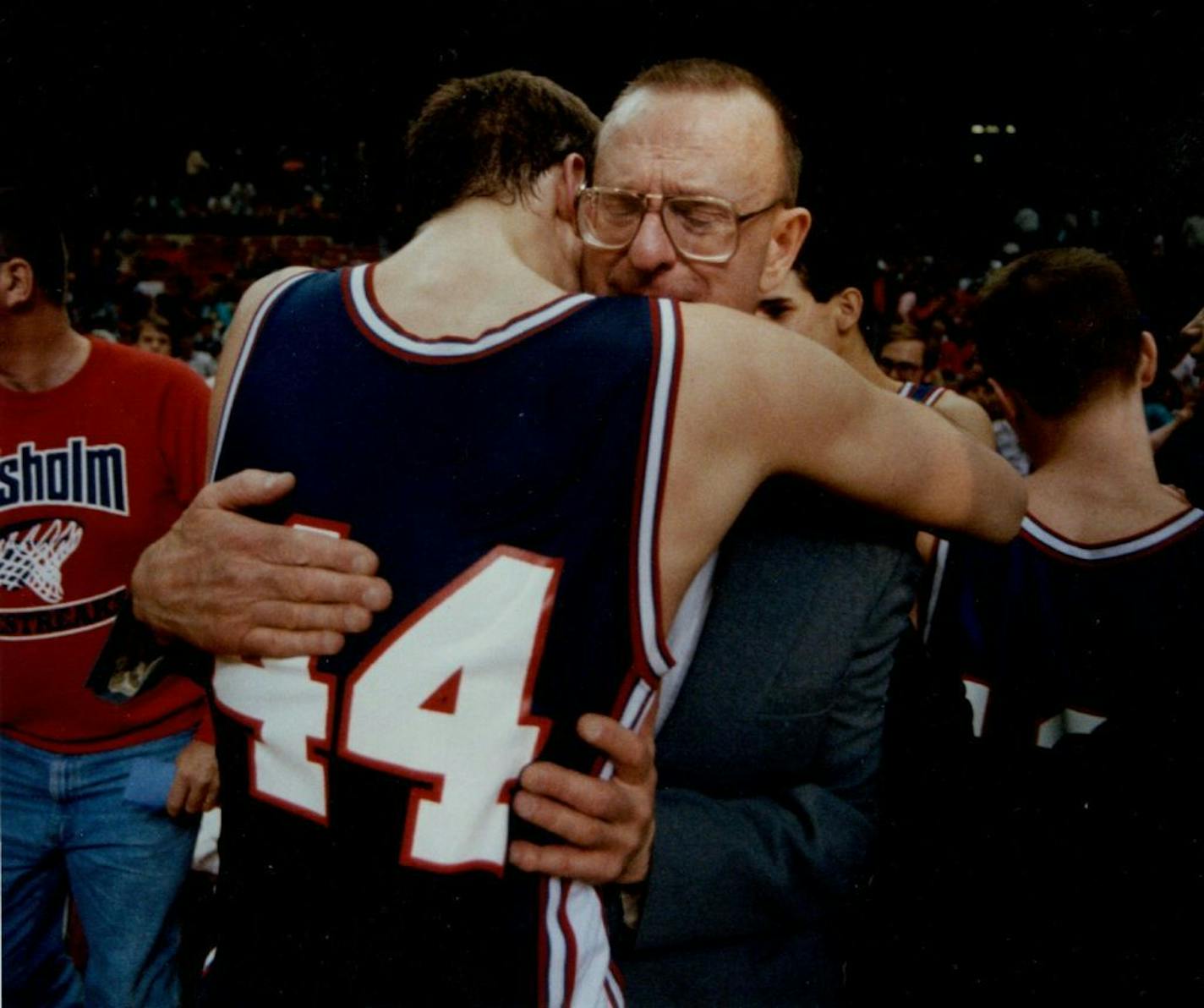 Bob McDonald hugged his son Joel after their Chisholm team won the 1991 Class A title.