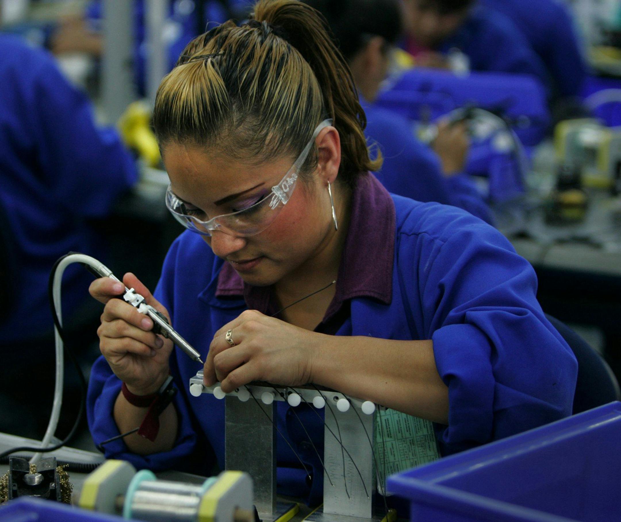 Communication headsets are made at Plantronics, a maquiladora in Tijuana, Mexico. (Peggy Peattie/San Diego Union-Tribune/TNS) ORG XMIT: 1195809