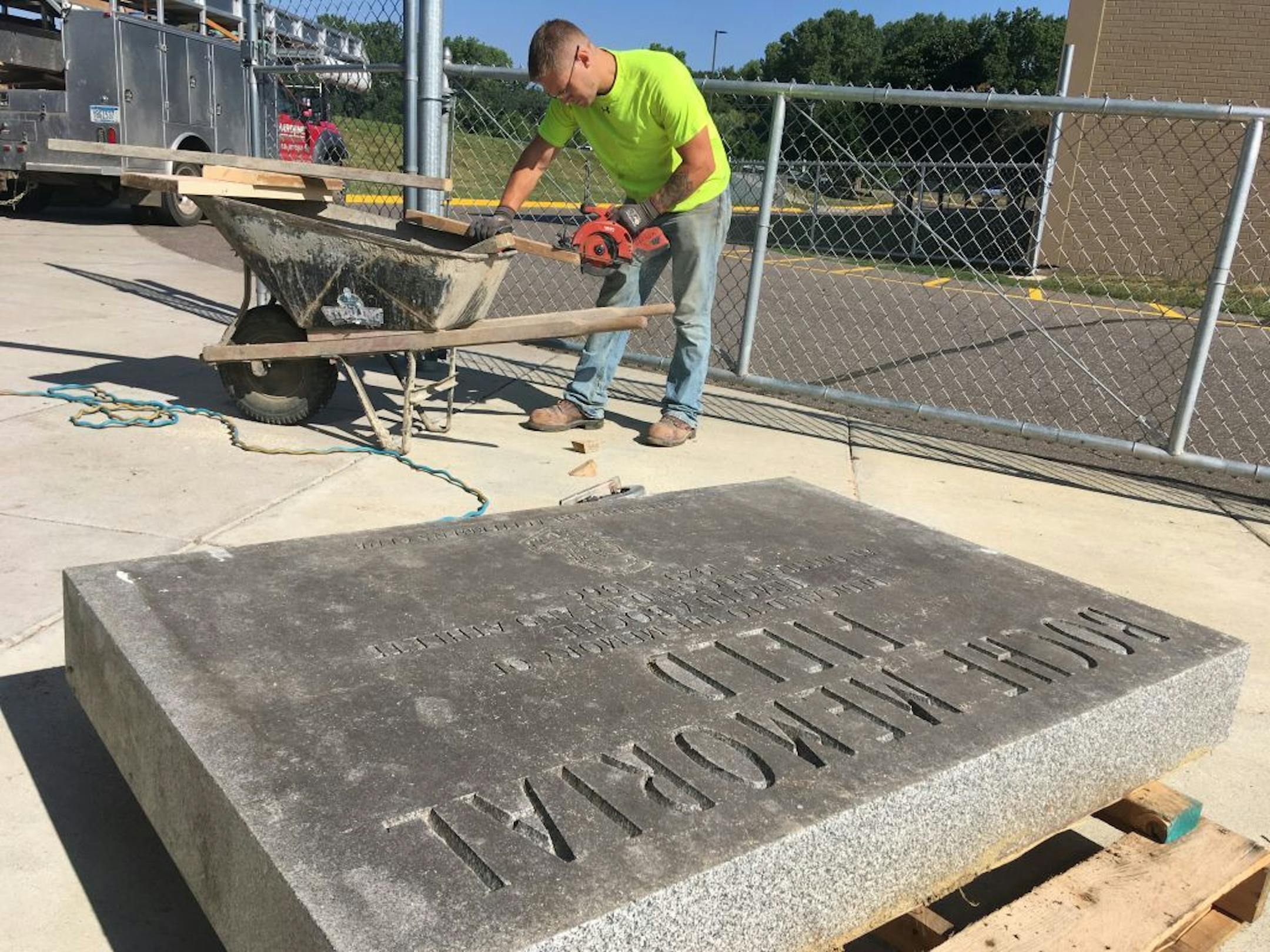 Workers prepare the Timothy Boche memorial to be put up again.