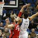 Timberwolves center Karl-Anthony Towns stretched out to shoot the ball against Raptors center Jonas Valanciunas in the second half Wednesday of the Wo