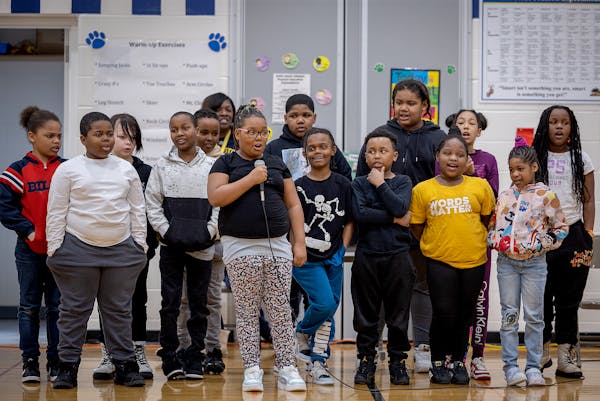 Students brave the stage and give a presentation during a school awards assembly at Nellie Stone Johnson in Minneapolis, Minn., on Friday, March 24, 2
