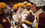 Brannon McManus, left, and tournament MVP Jack LaFontaine celebrated after the Gophers defeated St. Cloud State 4-1 on Sunday to win the Mariucci Clas