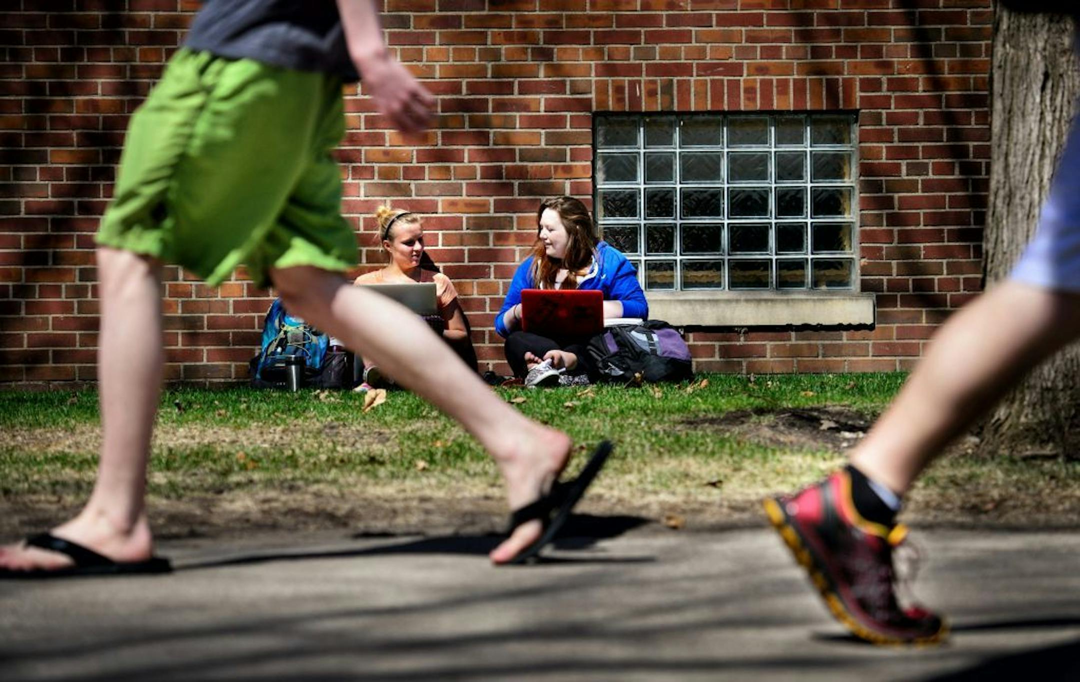 As fellow students walked in shorts, freshmen Julie Kurth worked on a law paper and Alexandra Davis polished her creative writing portfolio. As sunny temperatures reached well into the 60's Monday, University of Minnesota freshmen came out of hibernation to throw baseballs, lie in the sun and of course with only four weeks left before they pack up for the summer, study.