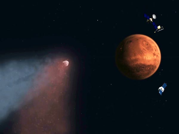 This handout artist's concept provided by NASA/JPL shows the Comet Siding Spring approaching Mars, shown with NASA&#x2019;s orbiters preparing to make
