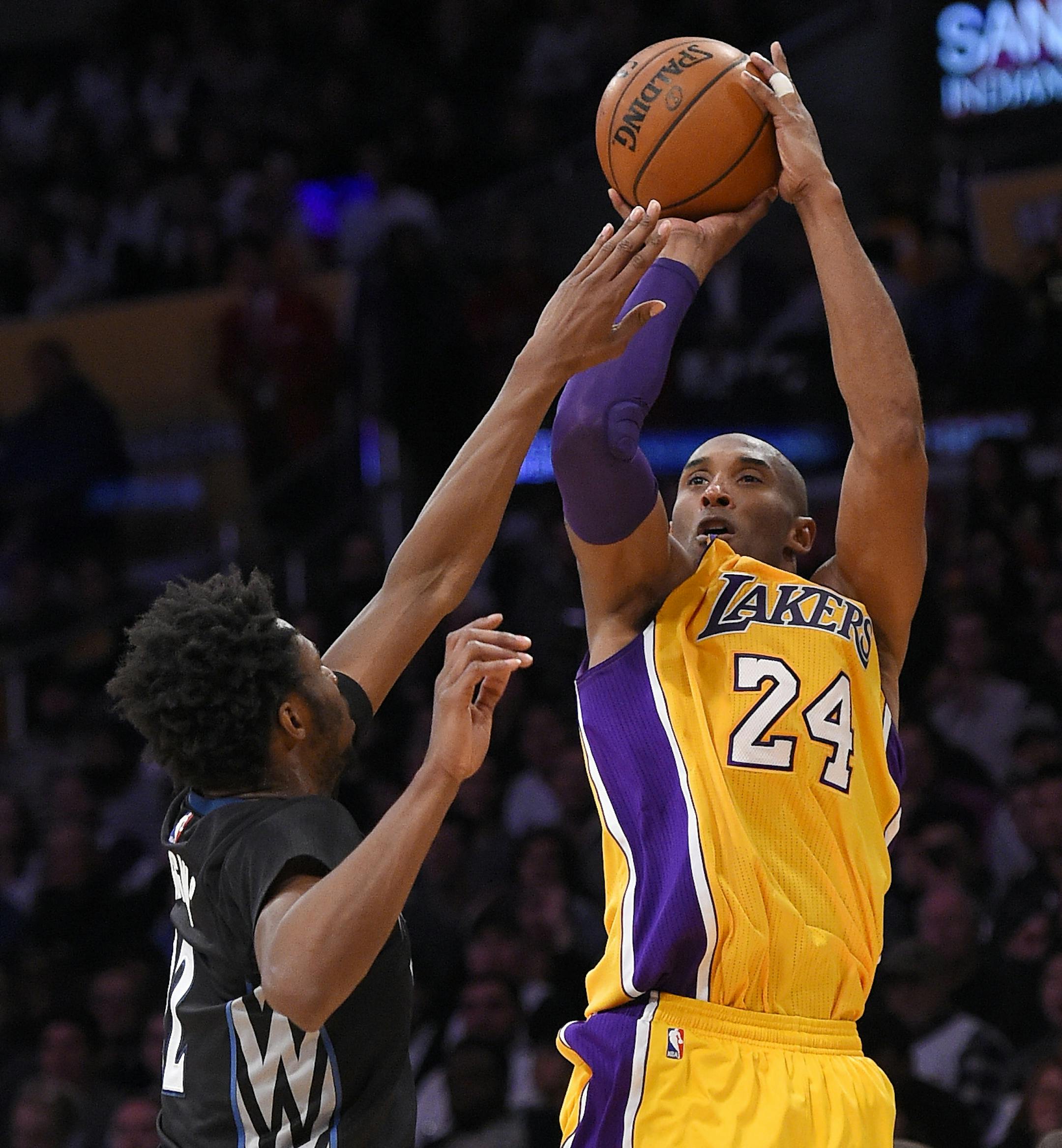 Los Angeles Lakers forward Kobe Bryant, right, shoots as Minnesota Timberwolves guard Andrew Wiggins defends during the second half of an NBA basketball game, Tuesday, Feb. 2, 2016, in Los Angeles. The Lakers won 119-115. (AP Photo/Mark J. Terrill)