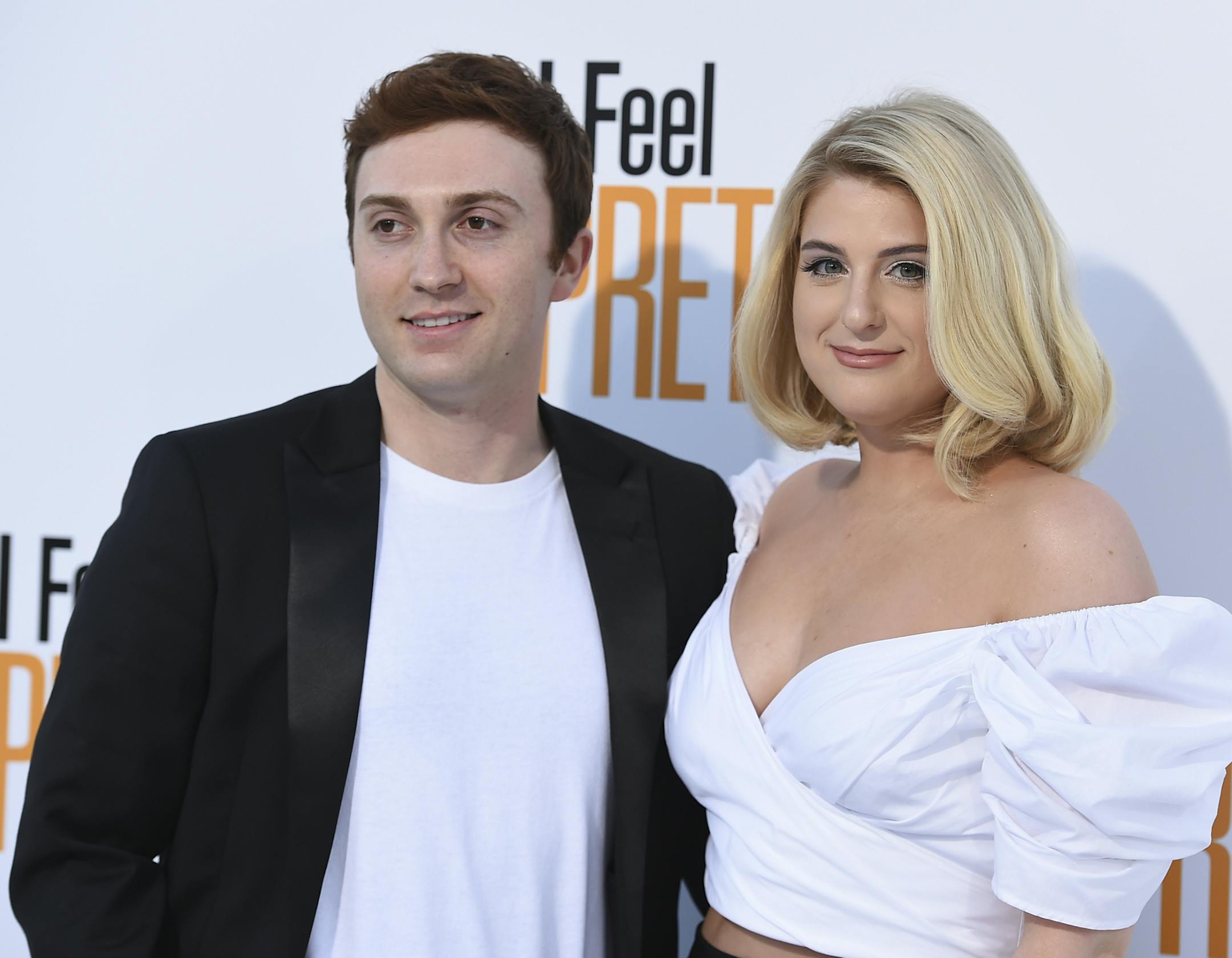FILE - In an April 17, 2018 file photo, Meghan Trainor, right, and Daryl Sabara arrive at the world premiere of "I Feel Pretty" at the Westwood Village Theater in Los Angeles. A publicist for the Grammy-winning singer on Sunday, Dec. 23, 2018 confirmed that Meghan Trainor wed actor Daryl Sabara in nuptial exchanged at the couple’s Los Angeles home on Saturday. (Photo by Jordan Strauss/Invision/AP, File)