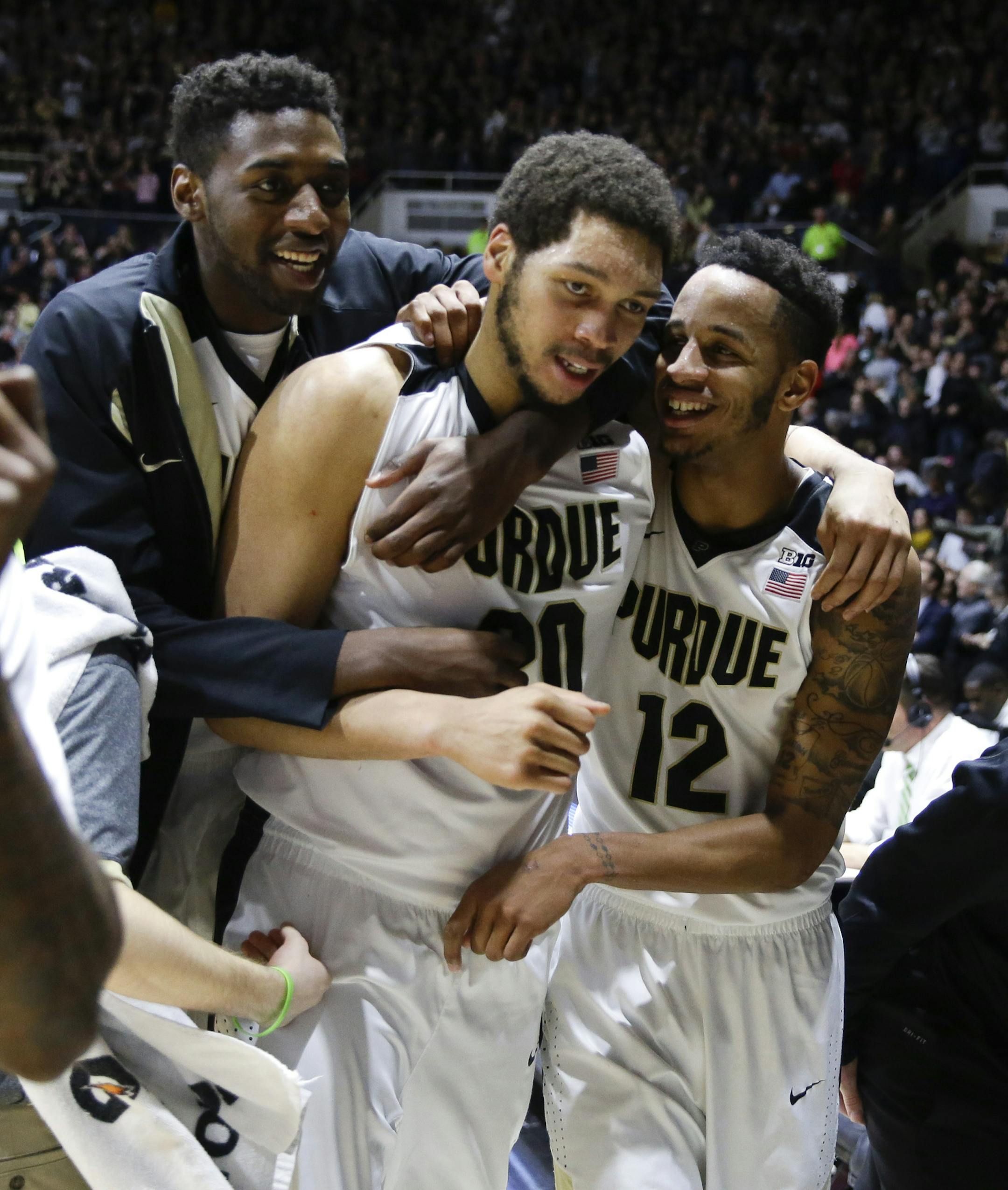 Purdue center A.J. Hammons (20), center, celibates with forward Vince Edwards (12) and forward Jacquil Taylor (23) following an NCAA college basketball game in West Lafayette, Ind., Tuesday, Feb. 9, 2016. Purdue defeated Michigan State 82-81 in overtime. (AP Photo/Michael Conroy)