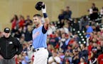 Minnesota Twins' Joe Mauer salutes the crowd after hitting a single against the Oakland Athletics in the fifth inning during a baseball game Friday, A
