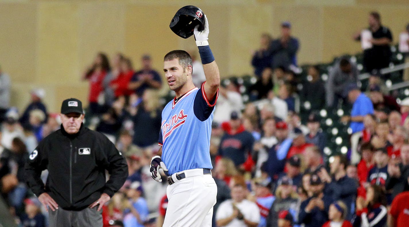 Minnesota Twins' Joe Mauer salutes the crowd after hitting a single against the Oakland Athletics in the fifth inning during a baseball game Friday, Aug. 24, 2018 in Minneapolis. It was Mauer's 2,086th career hit. (AP Photo/Andy Clayton-King)