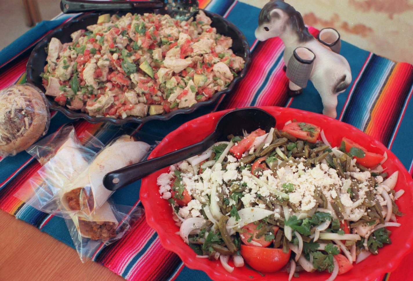 Some of the prepared foods that can be found at the El Burrito Market are taco plaza back left,burritos and cactus salad.