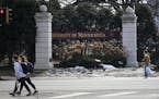 Pedestrians walked past a University of Minnesota sign along University Avenue in March.