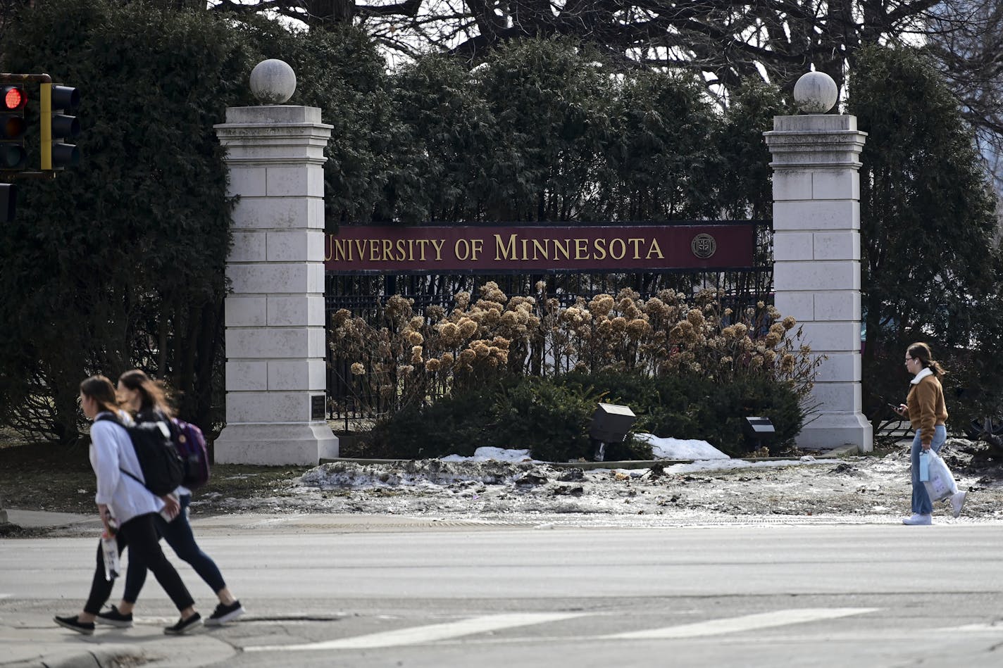 Pedestrians walked past a University of Minnesota sign along University Avenue in March.