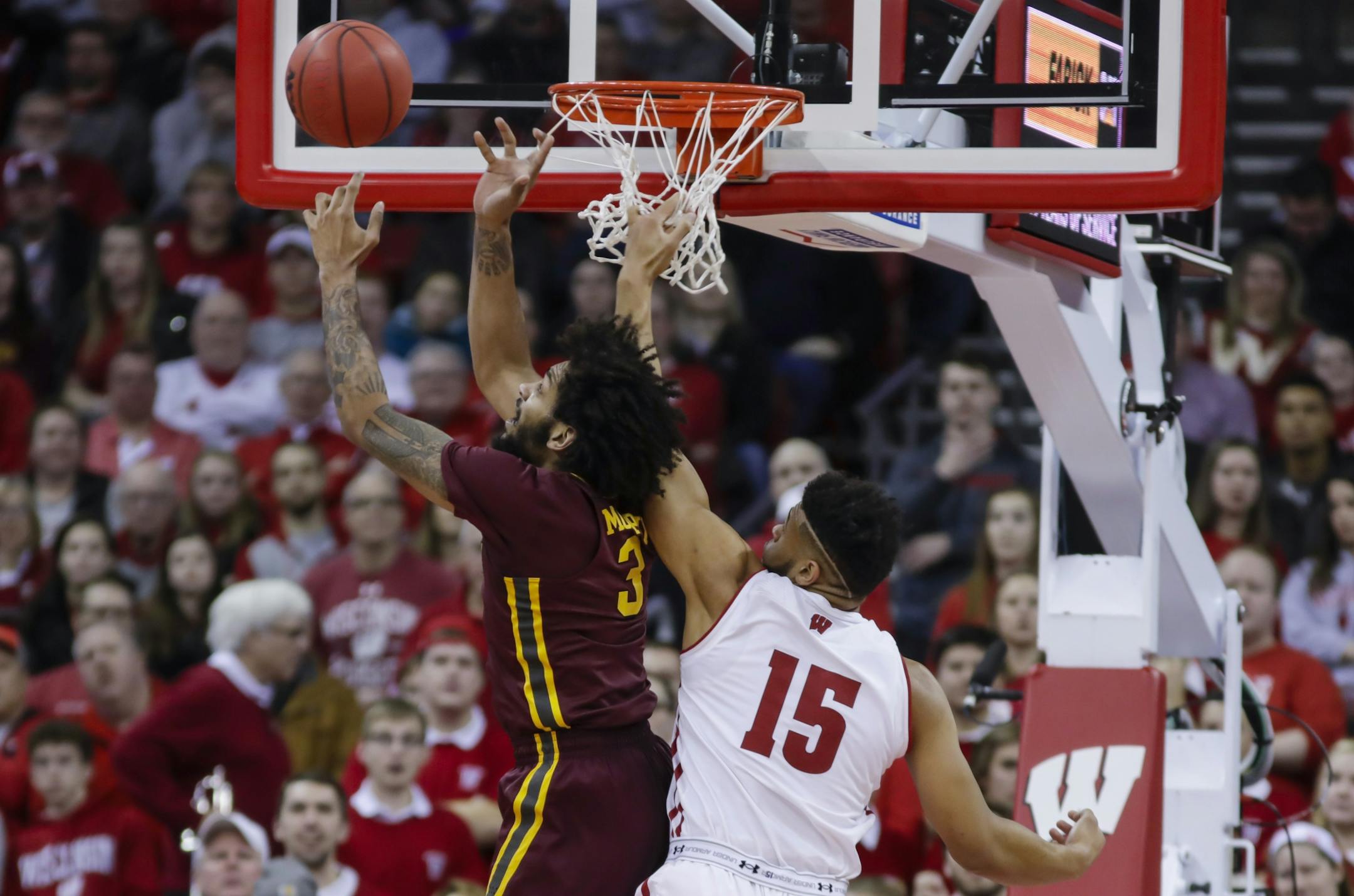 Minnesota's Jordan Murphy (3) goes after a defensive rebound against Wisconsin's Charles Thomas (15) during the first half of an NCAA college basketball game Thursday, Jan. 3, 2019, in Madison, Wis.