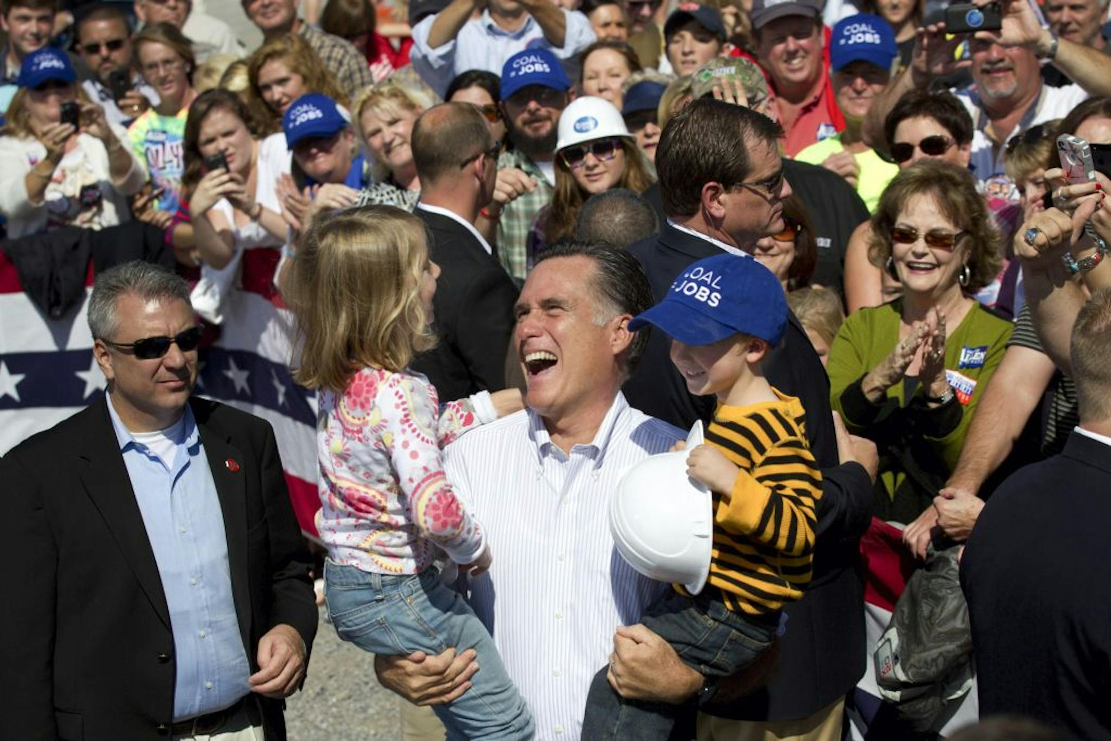 Mitt Romney, the Republican presidential nominee, holds children during a campaign event at Carter Machinery in Abingdon, Va., Oct. 5, 2012. The Labor Department said Friday that the nation's unemployment rate dropped below 8 percent in September – its lowest since the month President Barack Obama took office. Romney responded to the news by saying "this is not what a real recovery looks like."