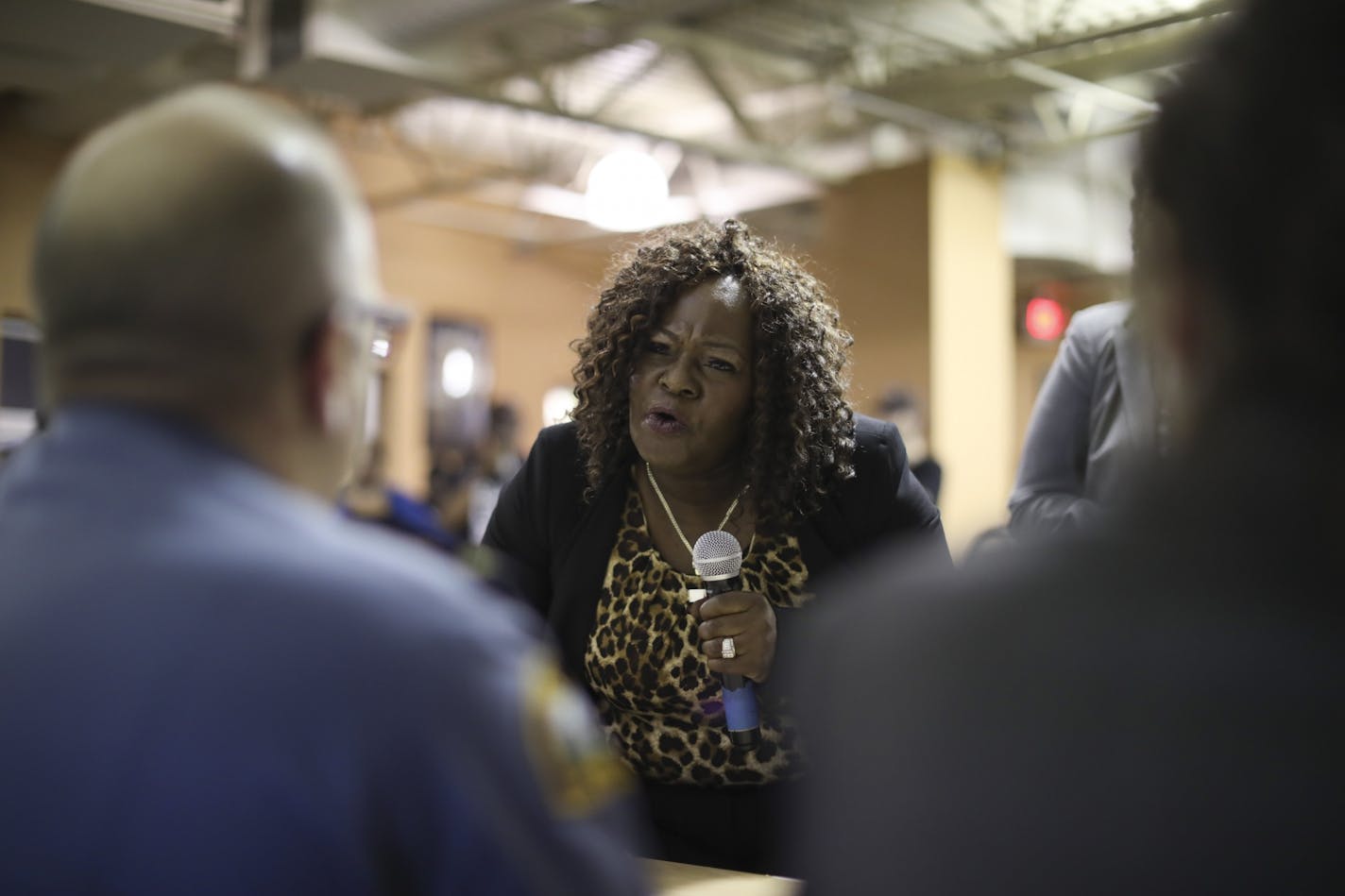 Kimberly Handy Jones told St. Paul Police Chief Todd Axtell, foreground left, about her son, Cordale, who was killed by police last month. She asked him what he would want if he were in her shoes.