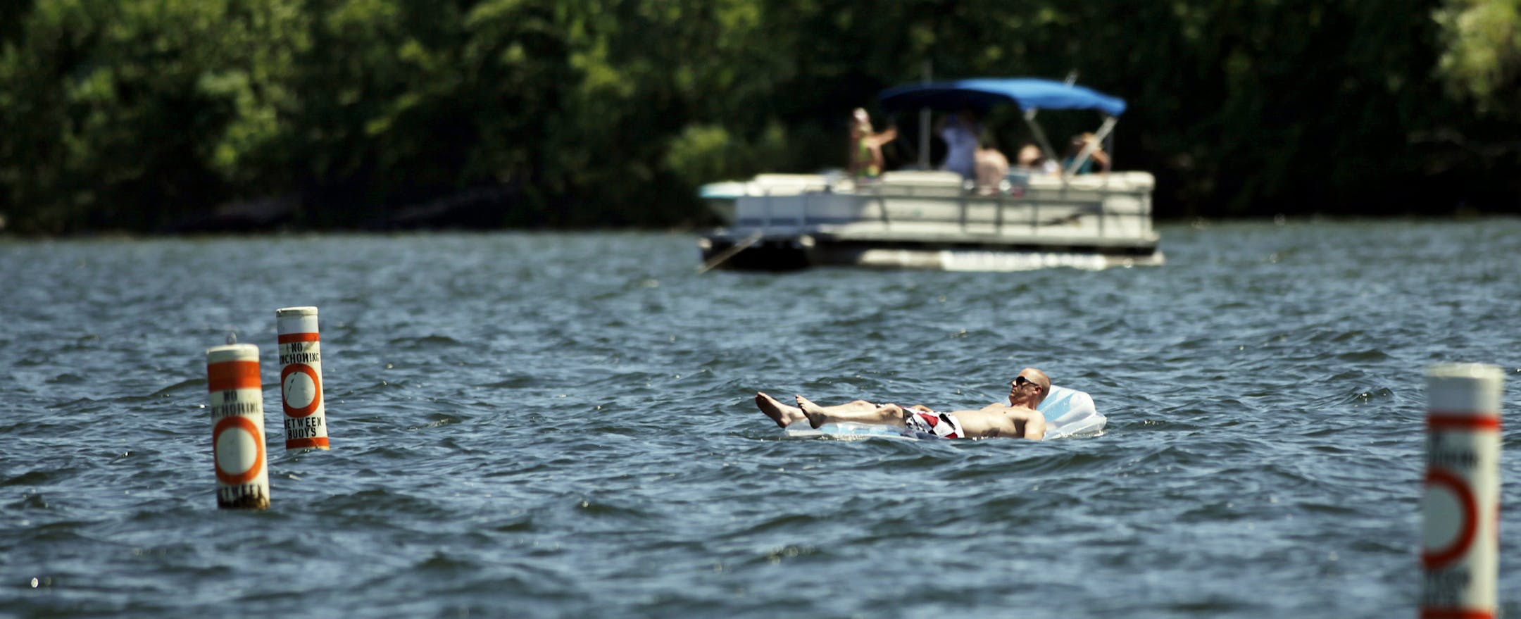 A man floats in Cruiser Bay at Big Island in Lake Minnetonka, MN on July 19, 2013. ] JOELKOYAMA&#x201a;&#xc4;&#xa2;joel koyama@startribune Three cases of E. coli have been found in swimmers at Big Island in Lake Minnetonka, and the state health department has issued its seasonal warning to swimmers. One person was hospitalized but all have recovered. We're checking to see if any beaches have been closed. Bacterial outbreaks like this become pretty common in the summer, as water temperatures rise
