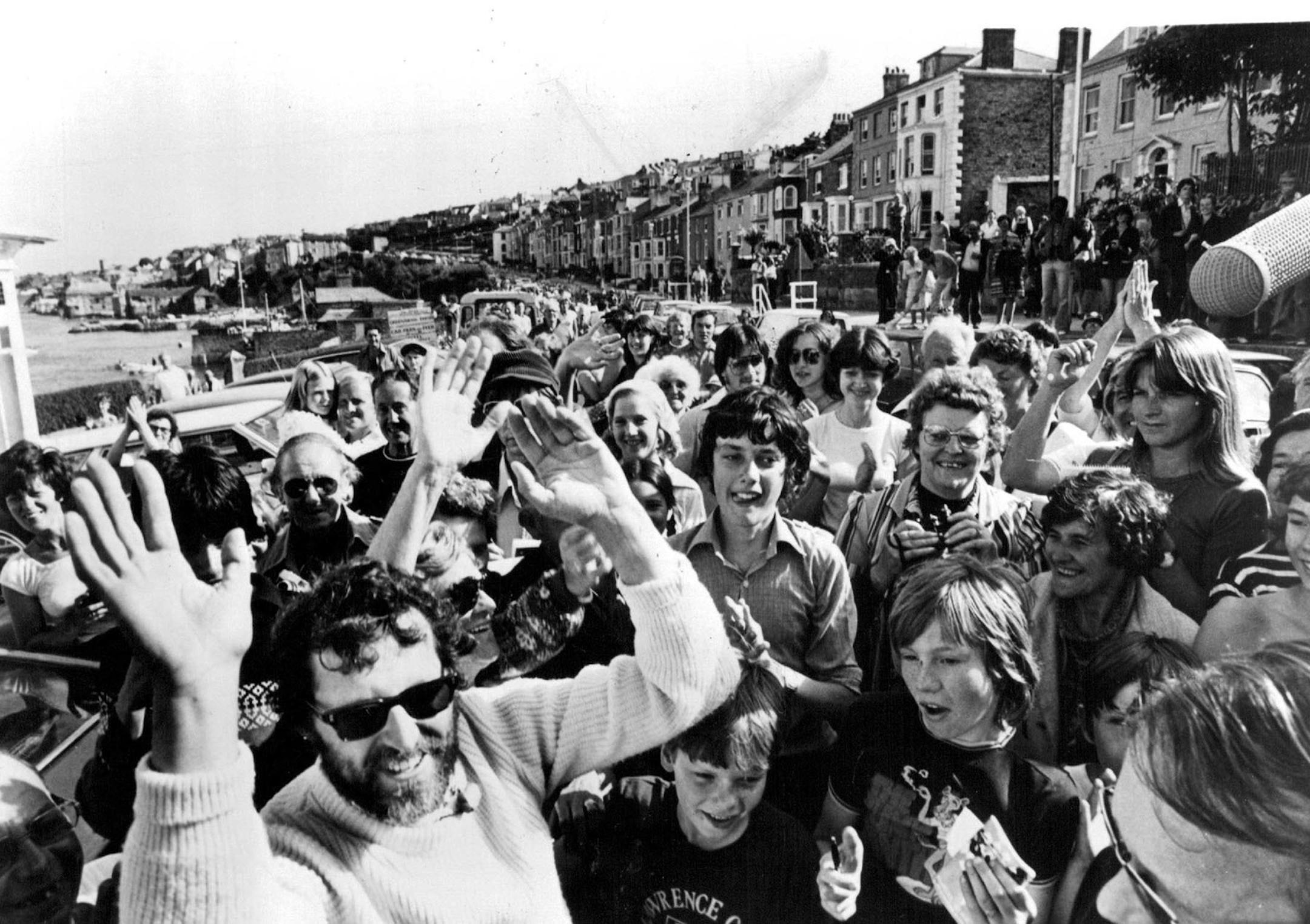 Gerry Spiess is greeted by residents of Falmouth, England, after completing his Atlantic Ocean voyage.