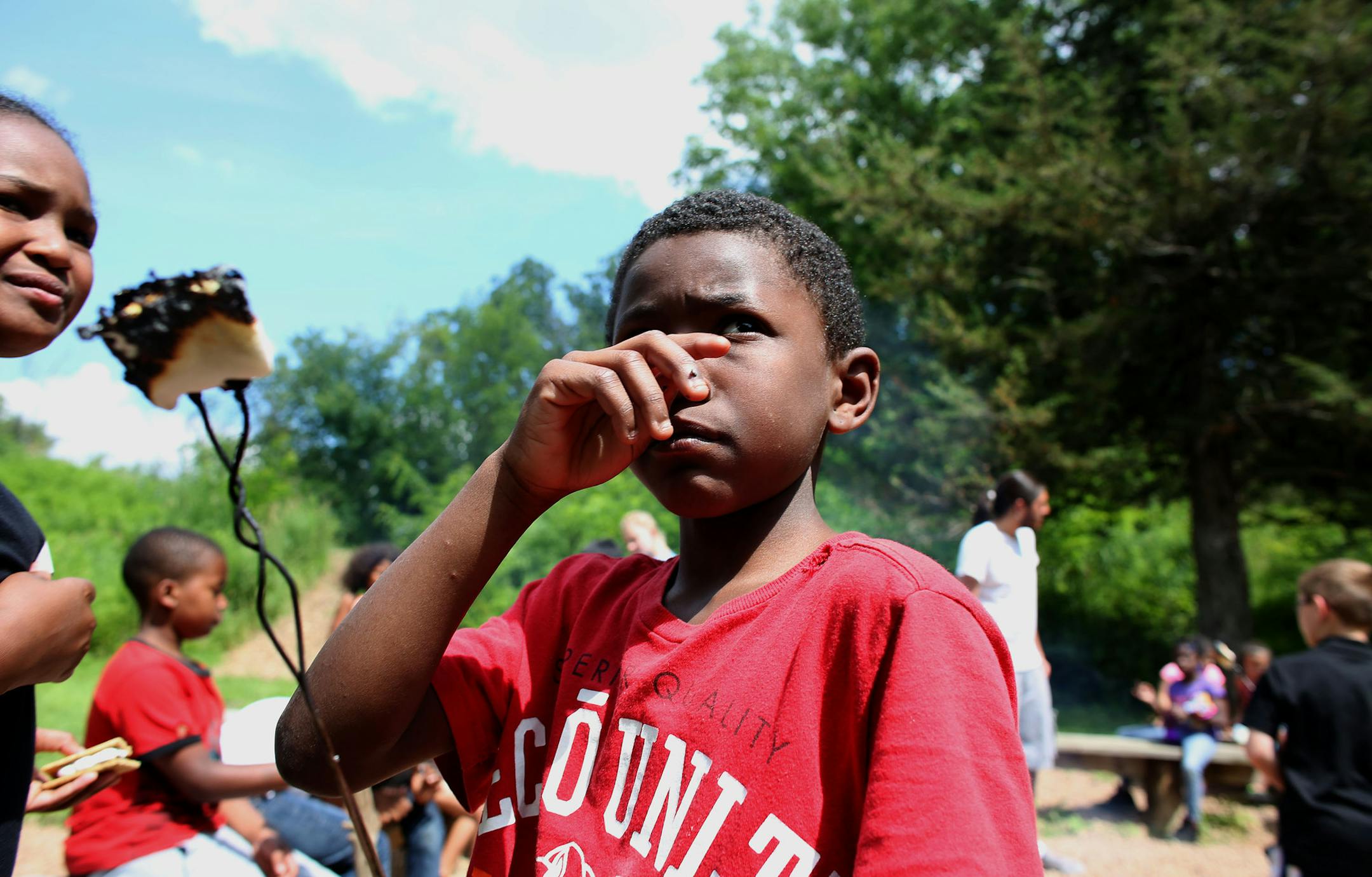 Charles Williams, 9, waited his turn to get chocolate and graham crackers to complete his smore during their rotation ] (KYNDELL HARKNESS/STAR TRIBUNE) kyndell.harkness@startribune.com The Boys and Girls Club summer camp in Mound, aka Camp Voyageur in Mound, Min. Wednesday, July 17, 2014.