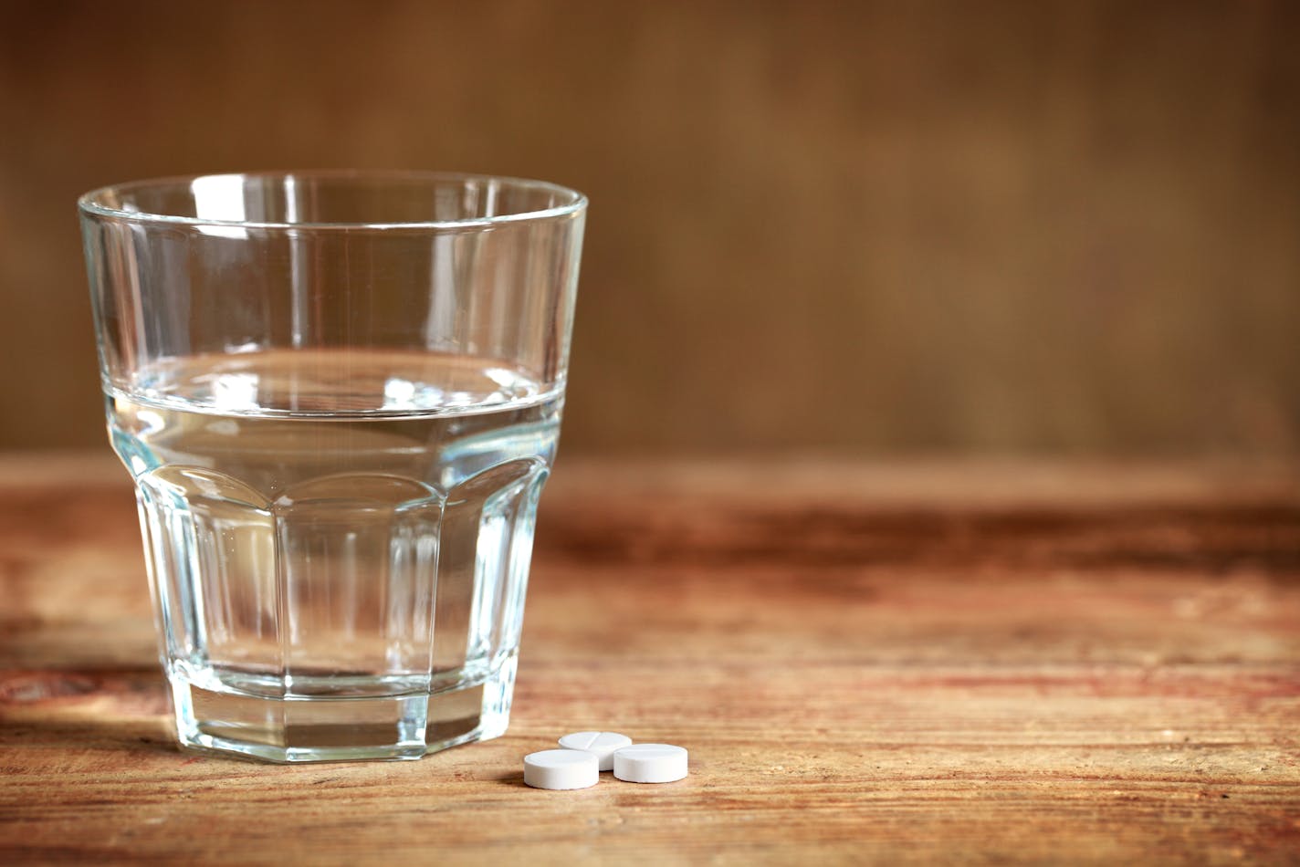 Tablets and a glass on the table.